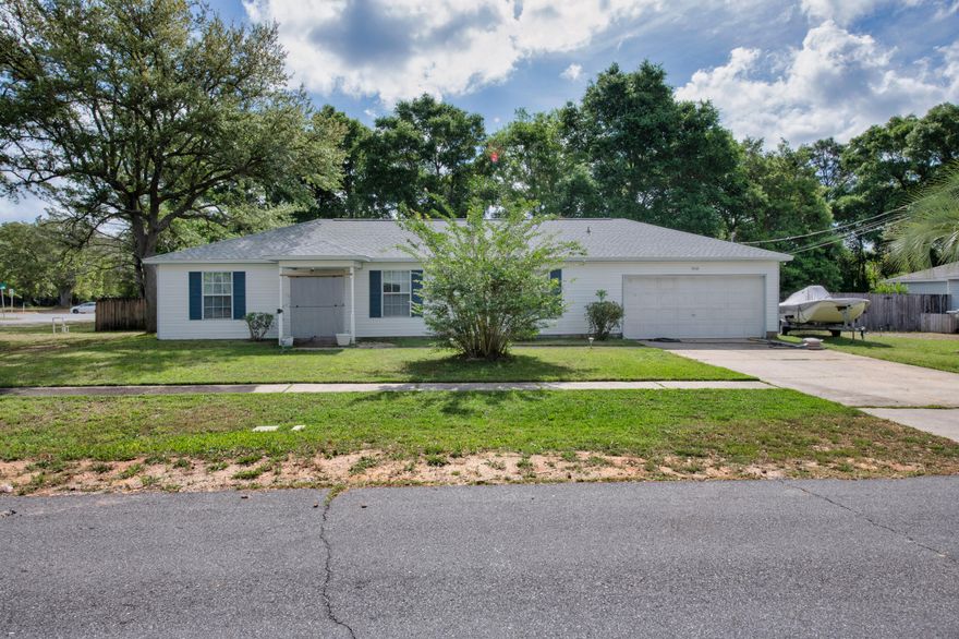 Looking for a cozy homestead vibe without the acreage upkeep? Welcome to this adorable and affordable home tucked just off Hwy 87 in Holley Navarre. Sitting pretty on a spacious corner lot with mature trees providing privacy, this home offers the perfect blend of comfort, function, and value. Before you even step in side you're greeted with a Bird Creek water feature, with water lilies, water hyacinth and continuous flowing water which mosquitoes hate but birds love! Step inside and you'll find a cozy yet surprisingly spacious split floorplan with loads of natural light and NO CARPET! Move right in to this floorplan that features a roomy dining area separate from the kitchen perfect for entertaining. Speaking of the kitchen, it's decked out with new appliances. Do you have a lot of tools and toys? Don't worry, there's a 
generously sized 2-car garage perfect for your vehicle, a workshop or storage! The roof was replaced in 2023 giving you peace of mind when it comes to insurance.
The neighborhood features sidewalks, and is just minutes from Navarre's popular restaurants (like Ye Old Brothers), shops, and only 15 minutes to the white sands of Navarre Beach. Looking for more outdoor fun, the home is only 50 yards to the south border of the Eglin Reservation where there are lots of outdoor recreation options (permitted needed).
The screened-in back patio overlooking the backyard is perfect for morning coffee, evening wine or hosting a get together with friends. Whether you're dreaming of chickens, raised garden beds, or just space to breathe, this property gives you that homestead feel without the hassle of managing acreage. There are already fig trees, grapes, gooseberries bushes and kiwis growing, as well as lettuce, squash tomatoes, peas, carrots and more. There are wild greens growing near the chicken coop for a free little treat for your feathered friends. A deep well pump was installed a few years ago to keep those fruits and vegetables growing with the automatic sprinkler system! All under $350K? Yep, it's a rare find!
