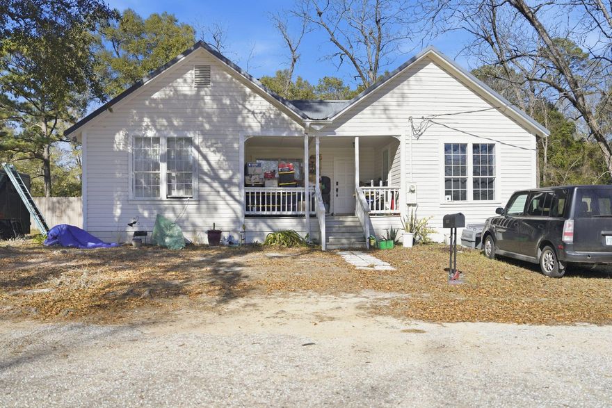 This 4 bedroom/2.5 bath home offers 2,664 sq ft of living space. Built in 1950, this property sits on a full 1-acre lot. The property features a remodeled kitchen with wooden cabinets, center island, granite countertops, and stainless-steel appliances. Custom cabinetry in the bedrooms. Hardwood floors run throughout with no carpet. Bathrooms include tile floors and double-vanity sinks. The home has a dedicated laundry area, and all windows and doors are in good condition. HVAC is in place with both heating and cooling. The roof is tin with a small leak noted on the front/side porch.Exterior features include three porches, a wooden fenced backyard, and mature pecan and pine trees providing privacy. The property sits in a quiet neighborhood with new construction nearby, supporting futur