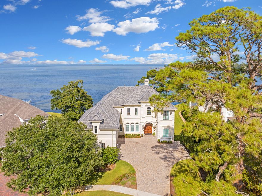 Welcome to your dream coastal retreat, where luxury meets unparalleled beauty in this exquisite bayfront home. Situated within the prestigious gates of an exclusive community, this residence offers the ultimate in privacy, elegance, and convenience. From the moment you step inside, you'll be captivated by the seamless blend of opulence and comfort, designed to cater to the most discerning homeowner.Imagine waking up each morning to breathtaking sunrises and ending your day with stunning sunsets, all from your private sanctuary. With uninterrupted views of the tranquil bay and Joe's Bayou, every room in this home offers a front-row seat to nature's most beautiful spectacles.This expansive home features five spacious bedrooms and five and a half lavish baths, ensuring plenty of room for relaxation and entertainment. Every inch of this residence is meticulously crafted, from the soaring 12-foot ceilings to the elegant European arches, highlighting the architectural excellence throughout. The luxurious mother-in-law suite provides a private haven for guests or extended family, complete with its own bathroom.
At the heart of the home lies a gourmet kitchen that is truly a chef's dream. Outfitted with a Wolf Range and top-of-the-line appliances, custom cabinetry that reaches up to the 12-foot ceilings, and stunning quartzite countertops. This kitchen is perfect for both culinary enthusiasts and those who love to entertain.
Step outside and immerse yourself in the best of Florida living. The sparkling saltwater pool invites you to soak up the sun, while the private dock offers direct access to the Point of Joe's Bayou and the bay. Boating enthusiasts will appreciate the convenience of direct boat access to the Gulf of Mexico, perfect for aquatic adventures or world-class fishing right from your backyard.
Located just minutes from upscale shopping, fine dining, and the vibrant harbor. The home puts you in close proximity to the best the area has to offer. Plus, with the beach just a short 4-mile drive away, you can enjoy sun-soaked shores and endless recreational opportunities whenever you please.
This property is more than just a home; it's a lifestyle. Embrace the luxury, tranquility, and convenience that this bayfront paradise offers.This is a rare opportunity to own the most stunning custom home in Destin, offering both the best Bayfront views and a truly one-of-a-kind residence. Schedule your private tour today and step into a world of endless possibilities in this extraordinary waterfront retreat.
