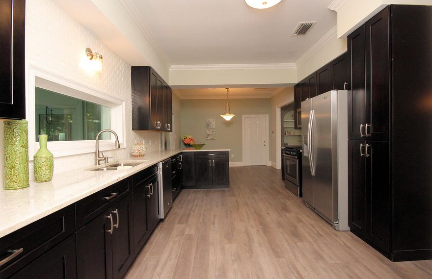 Gorgeous and completely remodeled 3 bedroom, 2 bath home in the heart of Niceville. There are so many details and features that you will love. Everything is pristine with new paint throughout inside and out. There is new hardwood style flooring throughout kitchen, dining, and living room and new carpet in bedrooms. Bathrooms have been updated with new vanities, sinks, tile, updated electrical and plumbing. Windows and doors have been replaced with energy efficient new ones. You will love the open kitchen layout with new beautiful stainless appliances, back splash and tile, sink,faucets, and lighting. The nicely landscaped yard has all new sprinklers equipped with rain sensors. Solid foundation and structure with great reinforcement with lifetime warranty! Everything is new! Must see today!