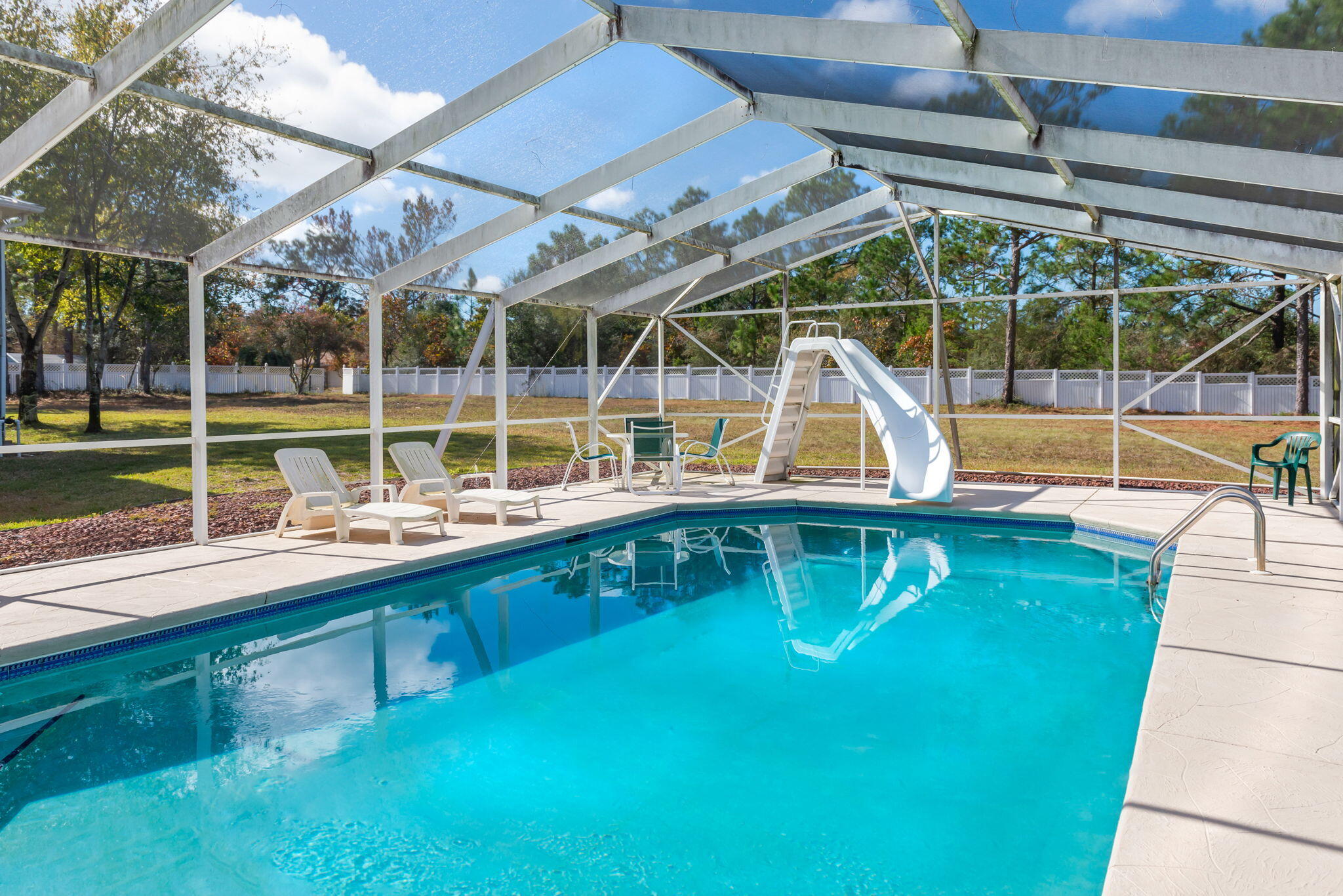 Welcome to your spectacular waterfront retreat nestled along the picturesque East Bay River with 1.3 acres! This stunning property offers the perfect blend of luxury, comfort, and natural beauty on an impeccable scale. As you approach, the charm of this residence is evident in its striking architecture, highlighted by a wrap-around porch that invites you to enjoy breathtaking views of the heated, saltwater pool and East River. Step inside and discover a seamless fusion of elegance and warmth, with oak wood floors gracing the expansive living spaces. The heart of this home is a dream kitchen featuring two sinks, storage and decor that effortlessly complement the richness of the oak wood floors. This space is designed for both functionality and style, creating a perfect hub for culinary