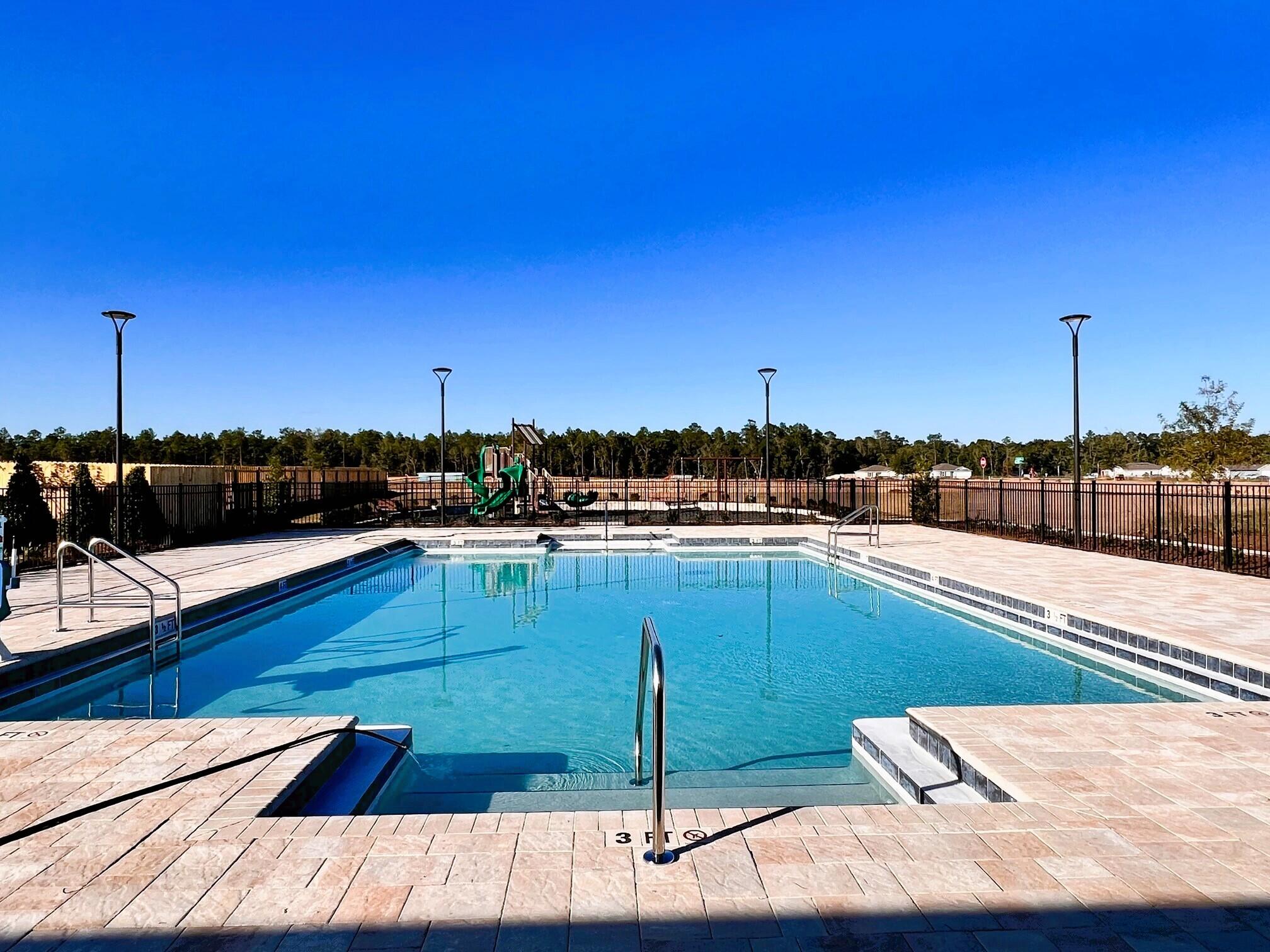 The charming Rivers Cove community offers residents use of it's gorgeous Community Pool, Community Room and Play ground.  The ''Sullivan'' plan is a cozy cottage style home with no wasted space, a desirable open design for relaxed living. A stylish 4 bedroom, 2 bath home, plus a large storage room. Easy care beautiful wood look flooring, delightful kitchen with stainless appliances, quiet dishwasher, smooth top range, built in microwave and pantry. Also included is Fabric hurricane door/window protection and a Smart Home 'Connect' system with several convenient Smart Home Devices.  MUST SEE.