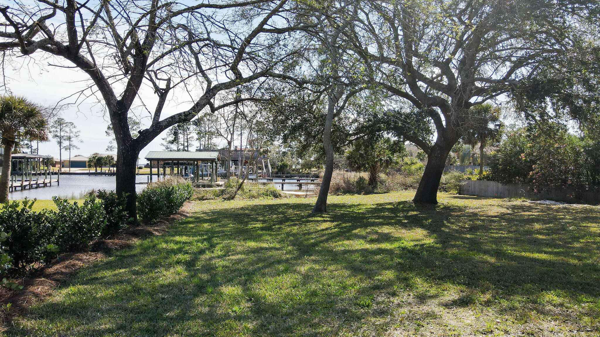 Welcome to waterfront paradise, where breathtaking views and luxurious living converge. This exquisite home is perched along serene shores, offering a lifestyle of tranquility and the most spectacular sunset views. You can relax on your 94 feet of waterfront which includes a dock. This beautiful brick rancher has a split floor plan with 3 bedrooms and 2 full baths. Many upgrades throughout including LVP flooring, stainless steel whirlpool appliances & slide in gas range. Also the roof, hvac & hot water heater have all been replaced in the last 3 years. There is a large heated/cooled sunroom that overlooks the breathtaking views of the water.