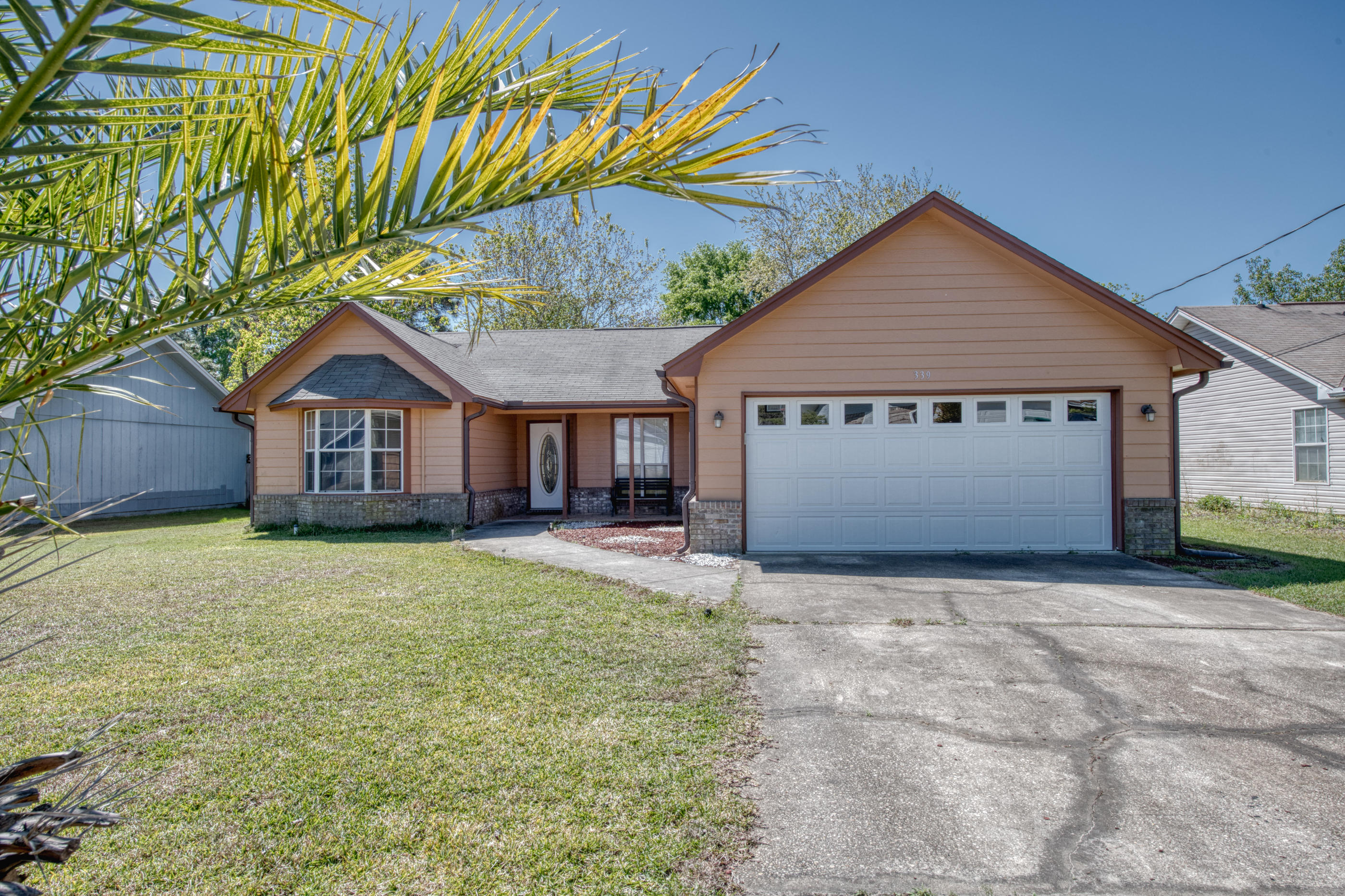 This must-see Mary Esther home has been beautifully updated and is within 5 miles of Hurlburt Field! Walk in to see an open main living area with vaulted ceilings, great for entertaining guests. Kitchen has been updated with new cabinets, stainless-steel appliances, and granite countertops in 2015. Split bedrooms, for added privacy into the master suite; which has a tiled shower and spacious walk in closet. Porcelain tile throughout the main living area and bathrooms and carpet in the bedrooms. Replaced water heater, HVAC, washer/dryer, irrigation pump and rain gutters in 2015. Spacious, fenced in back yard with screened in back porch. This home is located on the last street of a quiet neighborhood, which avoids unnecessary traffic. Come check out this move in ready home today!