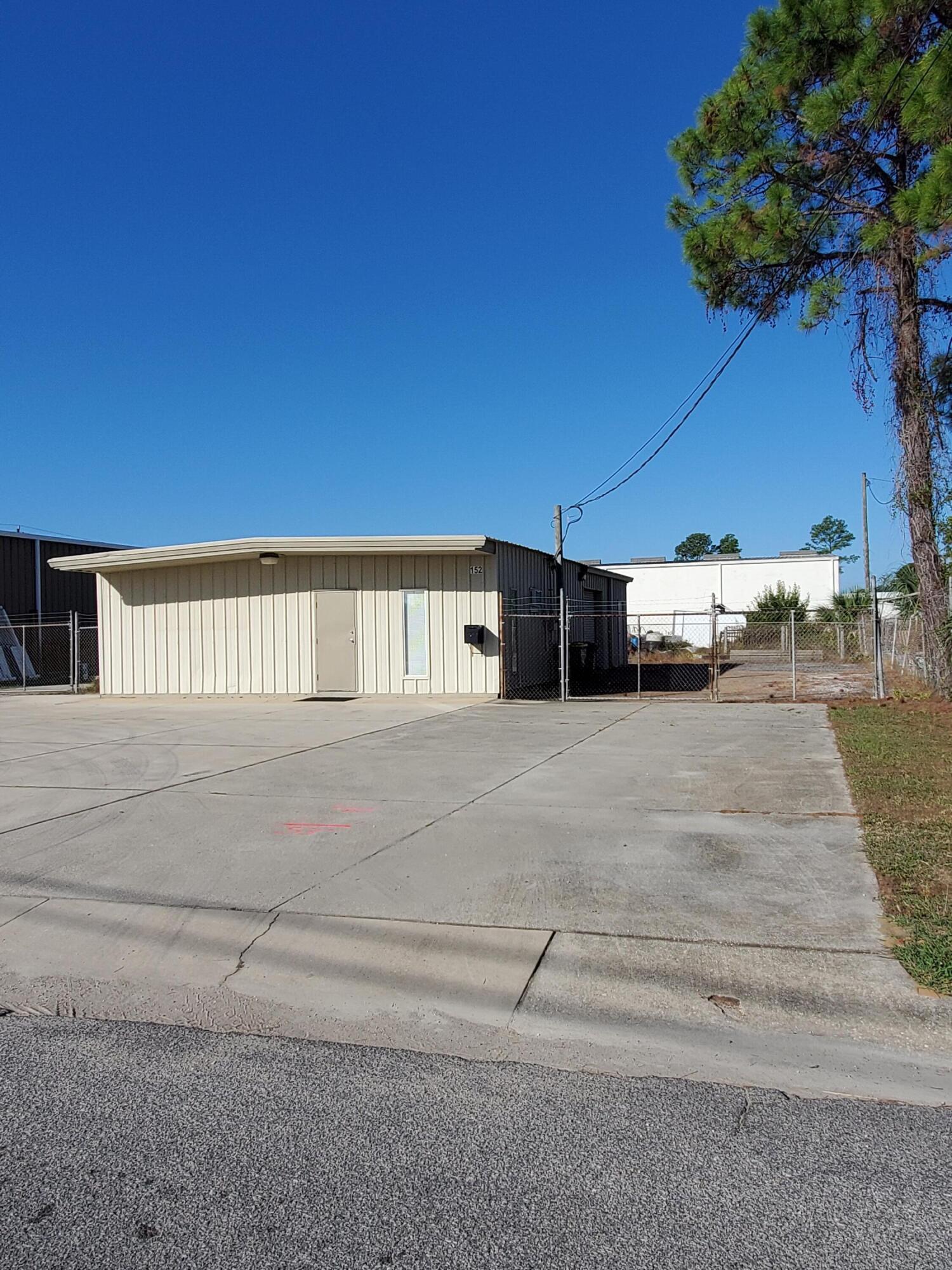 Great space for your office work and warehouse!  Office has window air and is 180sf.  Warehouse offers 1420sf with single roll up door, kitchen area, bath and small area for locked storage.  Outside fenced yard area to be used for business storage.  Call Property Management for more information: 850-244-2100