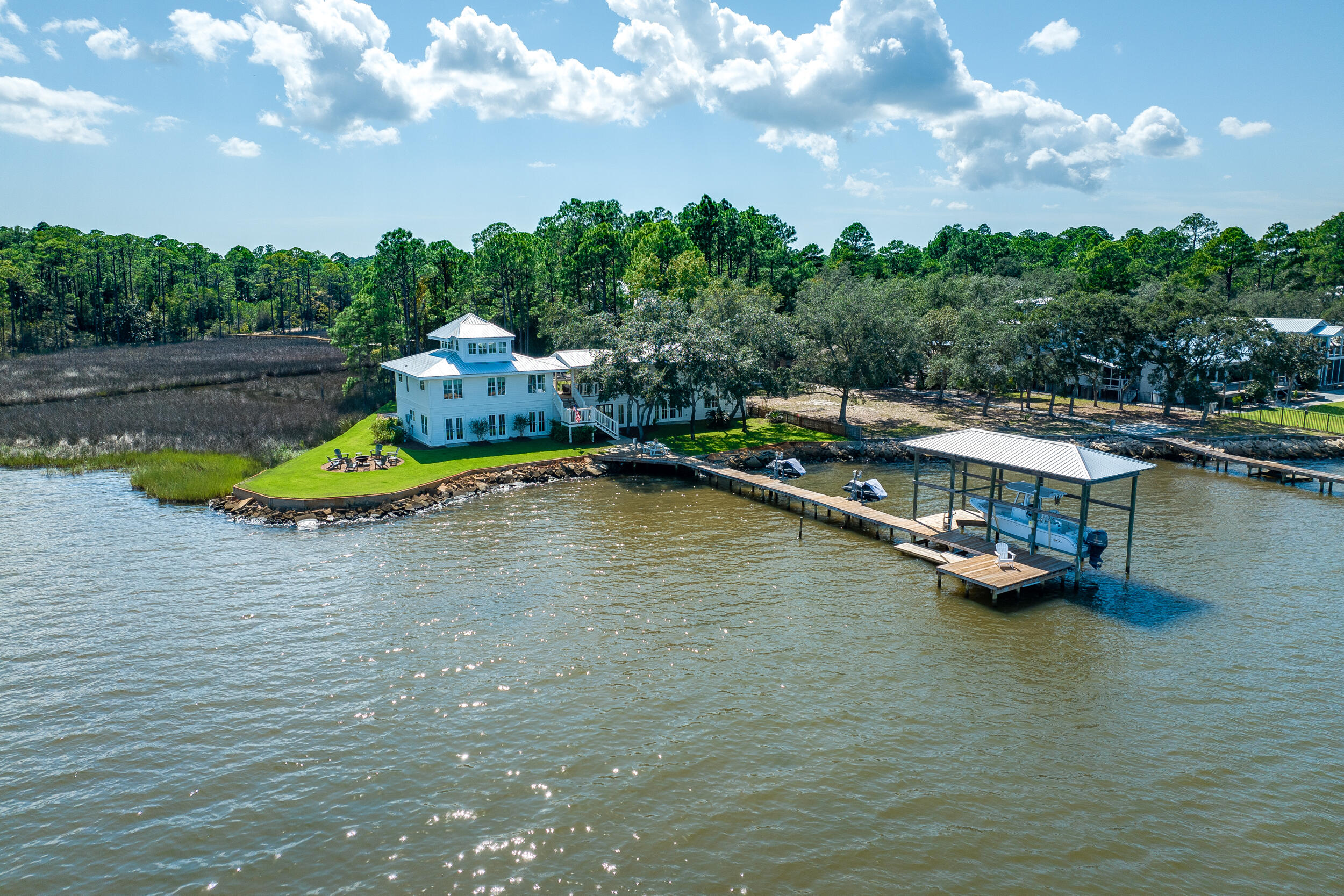 Nestled along the shores of the Choctawhatchee Bay, this extraordinary bayfront home has been completely reinvented and reimagined to offer the epitome of coastal luxury living. With an impressive 147 feet of pristine bay frontage and a spacious 3,934 square feet of living space, carriage house included, this property is a true coastal gem. Situated on a private corner lot, it boasts panoramic bay views that will take your breath away. Thoughtfully designed with modern luxury to include, high-end finishes, top-notch appliances, and a spacious layout. With 4 bedrooms, 4 1/2 baths plus loft, this home provides ample room for both relaxation and entertainment. The carriage house adds a touch of charm and versatility to the property, suitable for guests, a home office, or a studio. Relax on