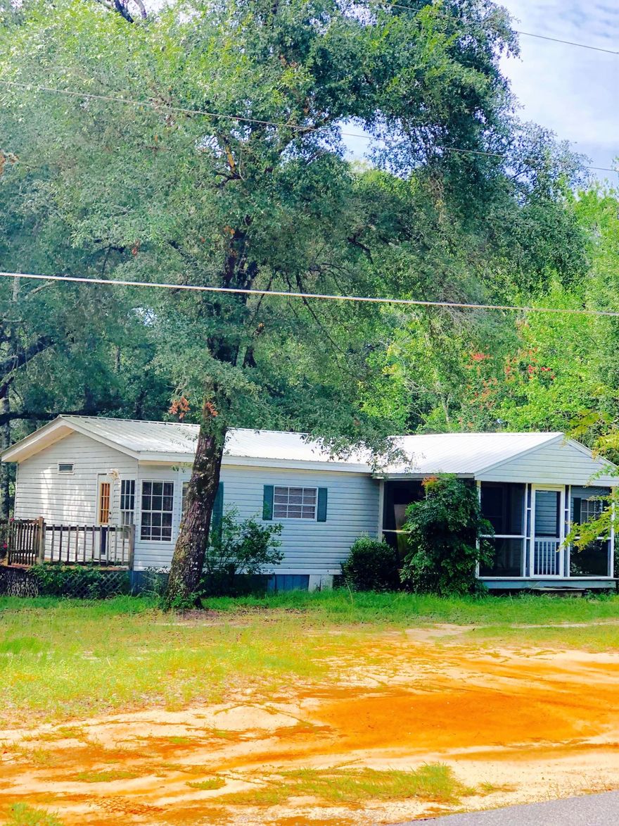 Located near Juniper Lake this 3 bedroom 2 bath home is surrounded by large shade trees only a half mile from public boat launch. Large yard and with plenty of storage for boats, jet ski's or travel trailer including storage shed. New metal roof, floors, and HVAC all installed within the past 2.5 years. Spacious living room and formal dining area. Kitchen features plenty of cabinets and counter space, large pantry, with adjoining laundry room with washer and dryer. Master bedroom has walk in closet. Master bath includes large tub with separate shower. Large new screened in covered front porch with new decking great for entertaining.