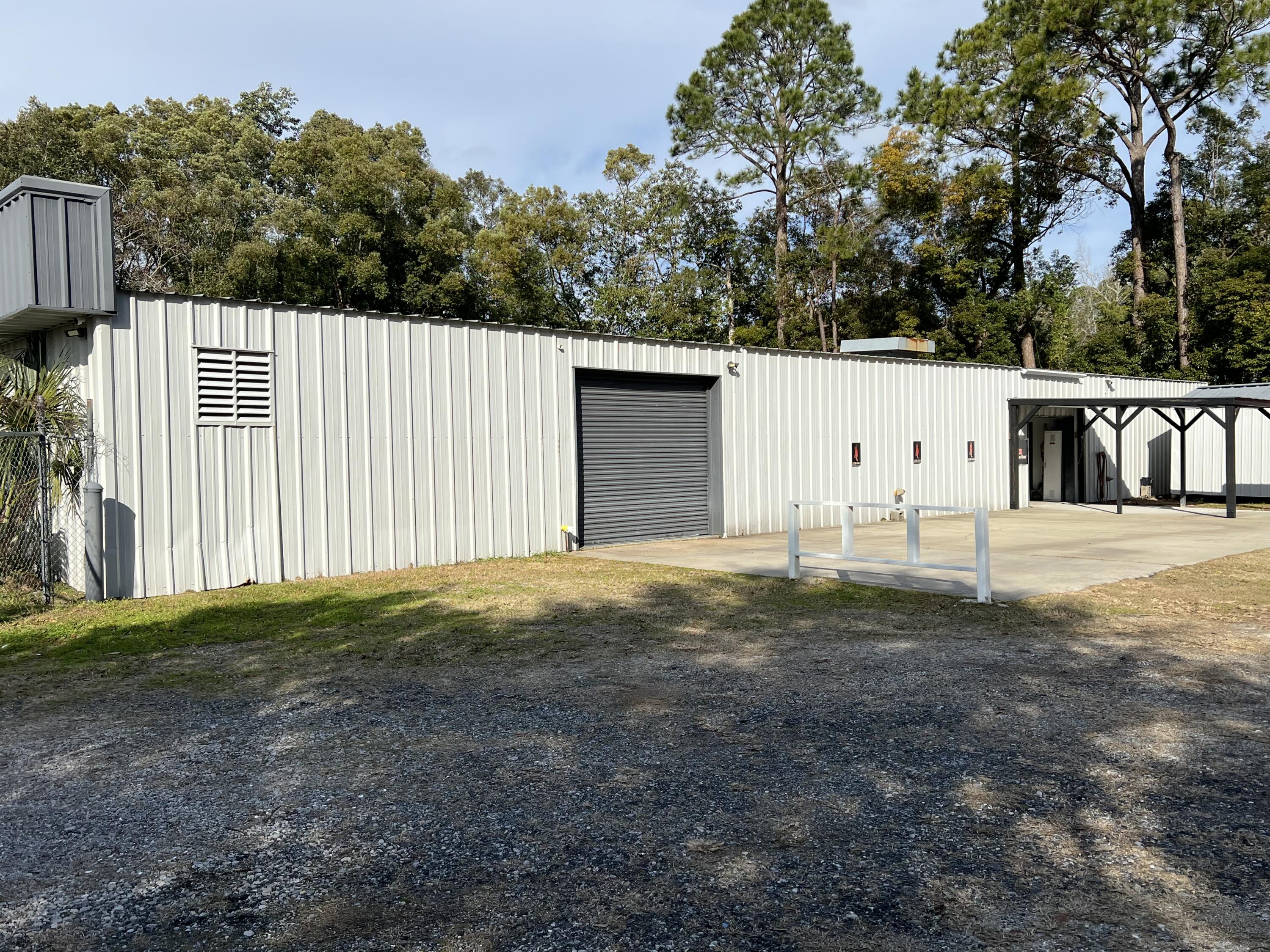Commercial building with 2 roll up doors. Includes a bathroom and LED lighting. Gated property with outside video surveillance. Outside parking and storage available. No mechanical, auto detailing or boat mechanics allowed. Signage space by the road and by the unit available.