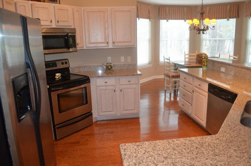 First floor, flat with absolutely no stairs! As you enter into the foyer, you will be welcomed with warm, hardwood flooring that is continued throughout the living area and kitchen. The spacious great room offers designer furnishings and lots of windows to allow for ample natural light as well as offer a portal to the great views of the lake and golf course. The kitchen is a chefs delight with granite counter tops, stainless appliances and an oversized dining bar. The master suite offers relaxing colors and views, as well as a large master bath with his and her vanities, separate shower and soaking tub. The two additional bedroom suites offer private baths as well. Relax outdoors on your private, screened in terrace overlooking the serene lake and lush landscaping. As an added bonus, the
