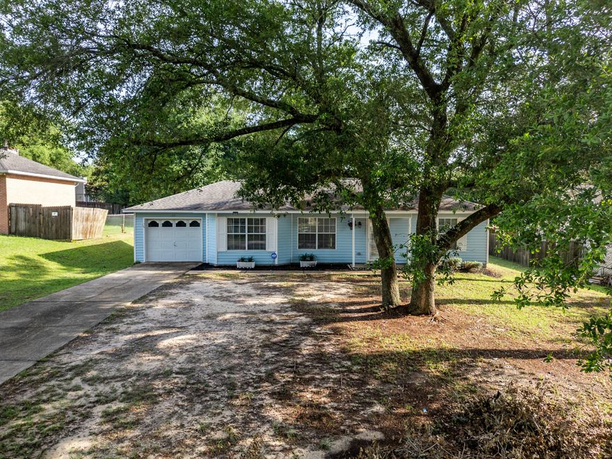 Charming and efficient, this Crestview gem offers the perfect blend of comfort and space! Nestled on a generous .32-acre lot, this home features an open floorplan that maximizes every square foot, making it feel light, bright, and welcoming. The split-bedroom layout provides added privacy, making it ideal for families, guests, or a home office setup. Notable updates include a roof in 2014 and a new water heater installed in 2021. Enjoy the peace of a spacious yard with plenty of room for gardening, entertaining, or future expansion. Whether you're a first-time buyer, downsizing, or investing, this property is full of potential!