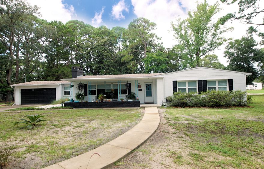 This mid-century modern home is better than new and located minutes from the lively, evolving downtown district of Fort Walton Beach! However, if you prefer to stay home, this house is perfect for entertaining! The kitchen has been completely renovated with cabinets which reflect the mid-century design and new appliances--including the Samsung Bespoke refrigerator. There is room to fit a table and chairs or use the adjacent dining area to enjoy your meals. The extra-large family room has a new, attractive electric fireplace for a focal point. One of the bedrooms is located off the dining area, but the current owners chose to use it as a den/office space. The other bedrooms are set on the East side of the, . . . (click MORE)