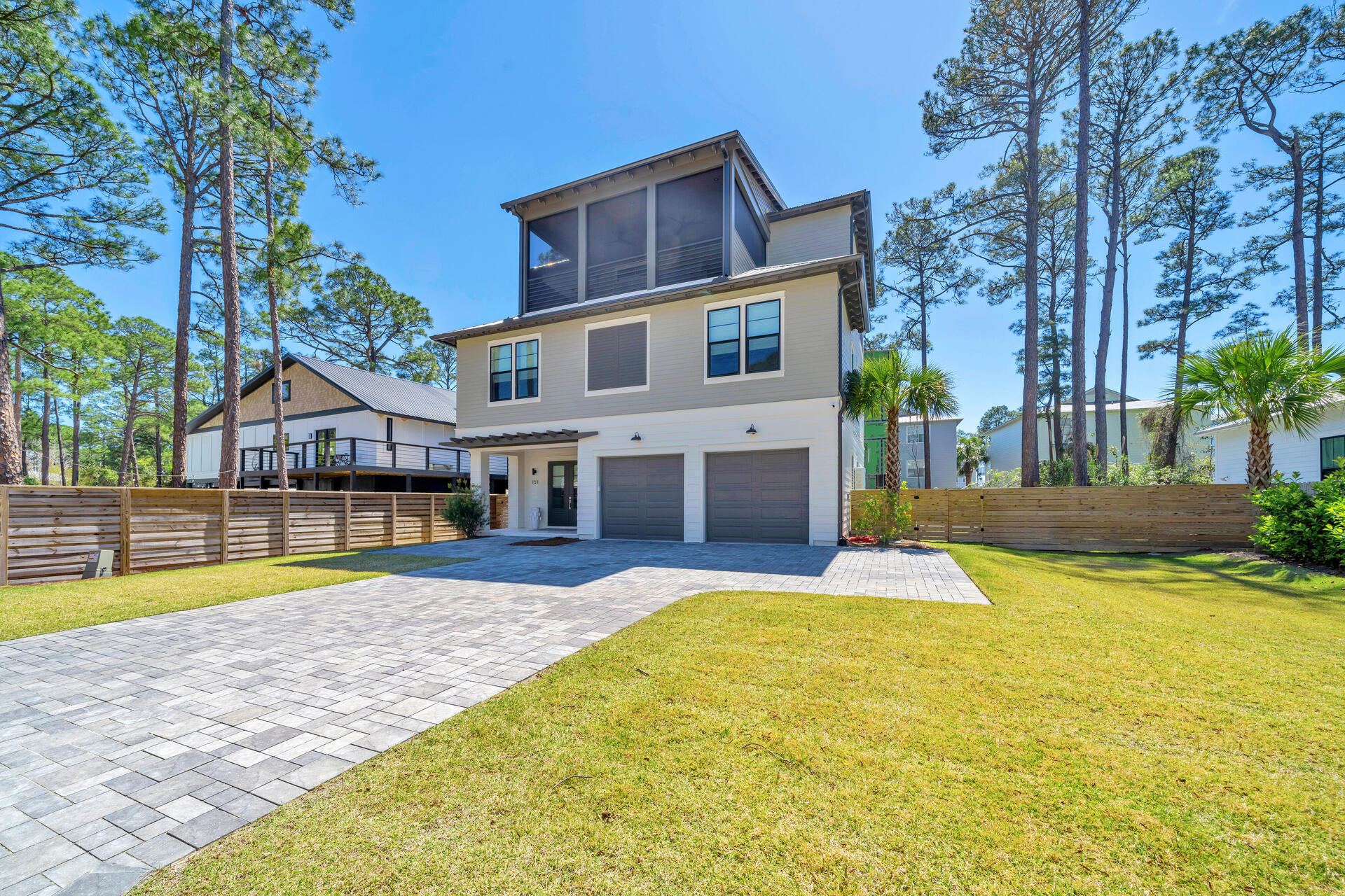 Built in 2022, this beautifully designed and elegantly furnished home in the coveted area of Oyster Lake on 30A. The modern floor plan includes multiple indoor and outdoor living spaces, an elevator which services all three levels, private in-ground swimming pool, outdoor kitchen, and much more. The furnishings and decor were curated by Beau Interiors in Grayton Beach. The moment you pull up to the property you will immediately notice the curb appeal, and features such as the oversized paver driveway, two car garage, screened in and covered 3rd floor patio, and the horizontal privacy fence surrounding the back yard of the property. As you head inside you are greeted by the foyer which leads you to the 2-car garage on the right, the stairs leading to the additional floors to the left, or straight ahead to the 1st floor sitting area, wet bar, bunk room with 6 built in bunks and ensuite bathroom, half bath, and laundry room with 2 stackable washers and dryers.
You can also head out to the back covered patio with outdoor summer kitchen, sitting area, and swimming pool with lounge pad.
Take either the stairs or the elevator to the 2nd floor where you will find the sleeping space. Here you will find the master bedroom and 3 additional bedrooms all with private bathrooms. The master suite has access to the 2nd floor covered balcony, large walk-in closet, double vanity, floor to ceiling tiled shower and soaking tub.
On the 3rd floor is the main living space and two more covered balconies. Here you have the sitting area, dining table for 10, and kitchen with quartz counter tops and kitchen island/breakfast bar. All stainless-steel appliances adorn the kitchen, and the oversized, walk-in pantry is something of dreams. There's even another storage closet inside the pantry where the 3rd floor HVAC can be found. Outside on the back facing patio you have yet another sitting area and ceiling fans which can also be found on the front facing balcony which additionally is screened.
Being adjacent to 30A means beach access, dining and entertainment are all just a walk or golf cart ride away. Don't wait, schedule your private showing TODAY!