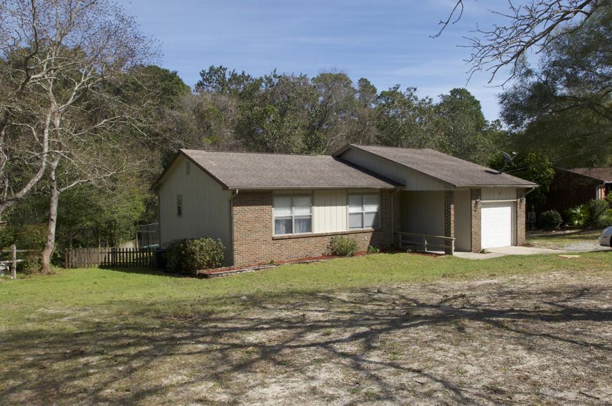 Freshly professionally painted, renovated charming home in Niceville's central Creekside neighborhood. Spacious rooms, custom cabinets, stainless steel appliances, wood floors, fenced backyard backing up to a greenbelt-this is the must see home you have been waiting for! Lovely living room has built in custom cabinets for plenty of storage. Master bedroom has an update ensuite bath with a walk in closet and room for a king bed. The updates are endless- ceramic tile, new interior doors, updated lighting, 2 full updated baths, new HVAC, new slider out to a great deck overlooking a private, fenced backyard. Located on a quiet cul-de-sac on almost a 1/4 acre lot, you can walk to top Niceville High School, Ruckel Middle school and great shopping.