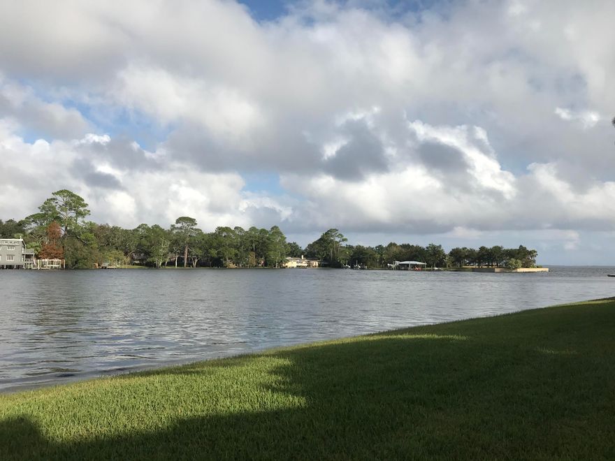 WHAT A GORGEOUS VIEW!  Enjoy your morning coffee or your evening beverage from the patio of this ground floor waterfront unit with an amazing view.  This is a great location in this gated complex,, 2 bedroom, 2 bath condo, open floor plan, tiled floors throughout, updated kitchen with stainless steel appliances and breakfast bar.  A/C new in 2016.  Spacious master bedroom and bath, and guest room with closet including shelving. Assigned parking space steps from this unit.  Community pool and tennis court.  Convenient location to Eglin AFB. Great unit for first time buyer or investor.