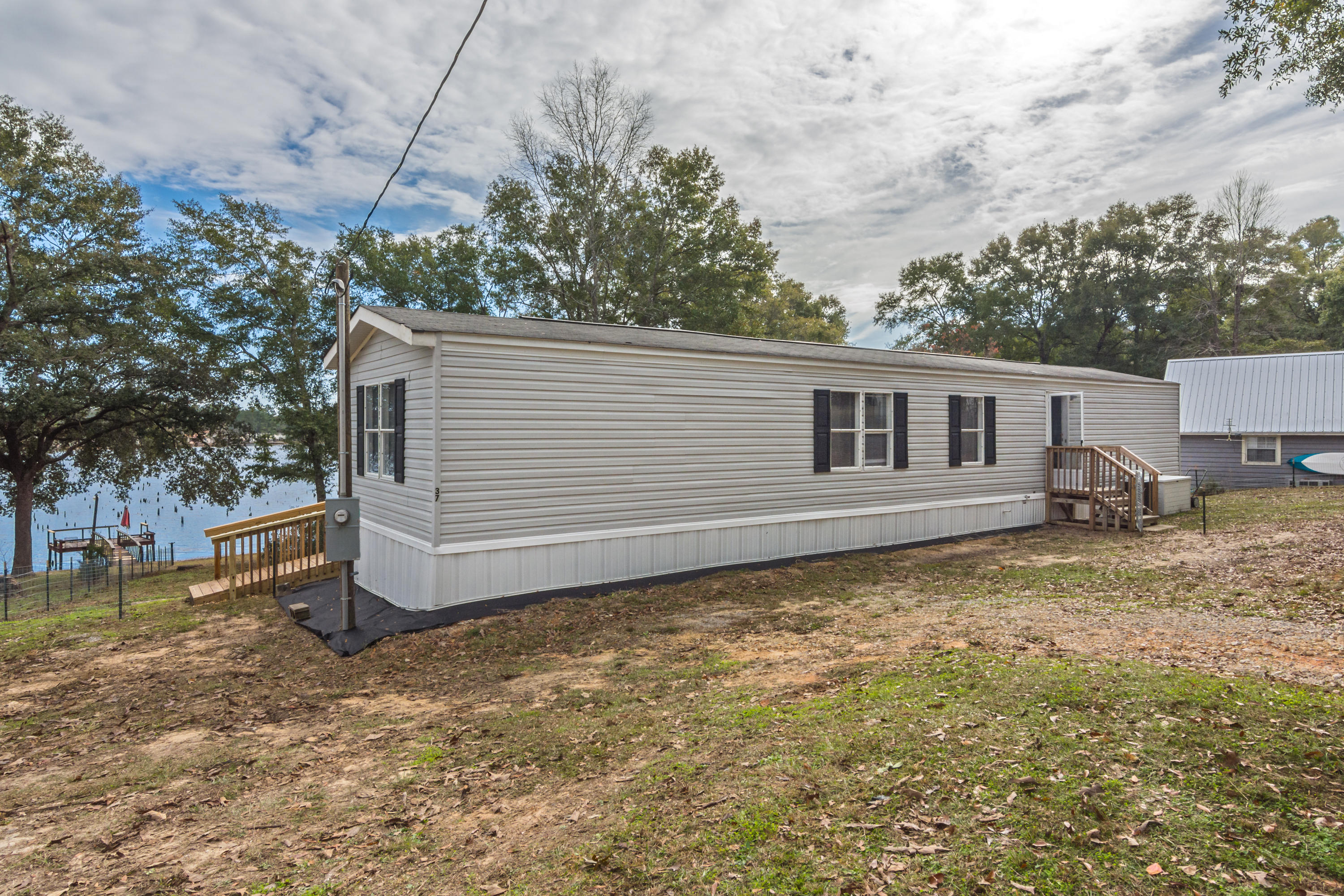 IMMACULATELY kept manufactured home located on Kings Lake. This TWO bedroom, TWO bathroom home has new flooring and paint throughout, a large deck with a ramp on the back and fenced yard up to the water with access to the dock.