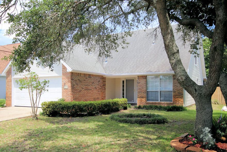 This cute brick front home offers 4 bedrooms and 2 and 1/2 bathrooms and 2 car garage, formal dining room and enclosed porch.  Nice size master bedroom is on the first floor and 3 bedrooms upstairs.  Roomy loft  on the second floor overlooks the living room area. This large living area has high cathedral ceilings, recessed lighting, a cozy fireplace and open to eat-in kitchen area.   Kitchen has lots of counter space, plenty of cabinets., Sliding glass doors lead out to the enclosed patio perfect for cookouts and family time. The kitchen has new stainless steel appliances. Fresh paint and new carpet installed. Fenced back yard, shed, lawn pump and sprinkler system. New garage door opener. Located just a few minutes to Hurlburt Air Force Base and white sand beaches. This house has it al