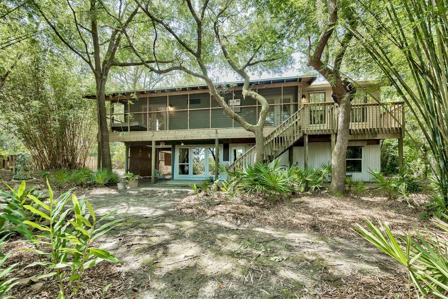 Off the beaten path and set among mature oaks and magnolias, this little slice of Eden enjoys a tranquil spot of unspoiled Florida greenery. Like its neighbors, this home enjoys a large lot with waterfrontage for capturing views of native birds and wildlife. This home provides family quarters for the relatives' visits. Offered for sale as-is. Beautiful hardwood flooring covers the living and dining areas. A screened deck provides private covered outdoor space with huge potential. The hall opens into a modern kitchen with granite countertops, stainless steel appliances and a pantry.