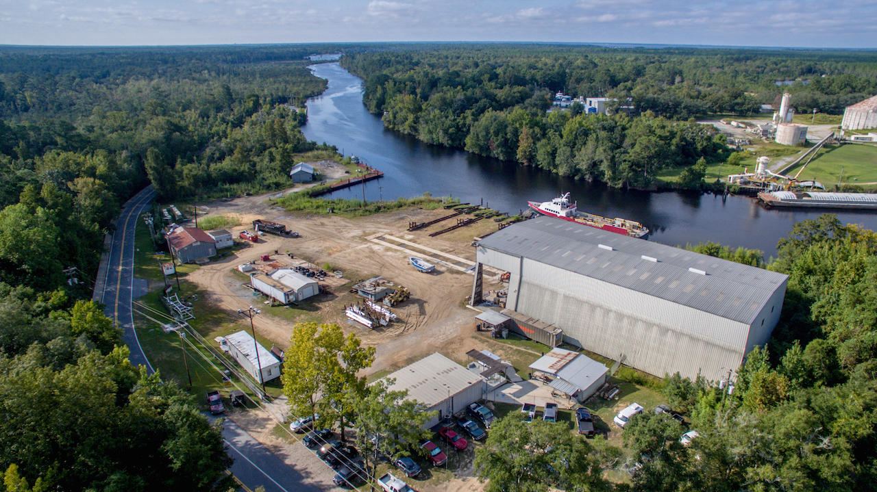 A very rare opportunity to acquire well over 5 acres yielding 1000+ feet on Lagrange Bayou and Four Mile Creek, navigable by barges to serve heavy industry. This industrial-zoned acreage would cater well to the defense industry, homebuilding industry, and of course, the continuance of its successful predecessor as a ship-building enterprise. Its christened fleet of 80+ vessels includes the Solaris passenger ship of Destin, boats designed to service the oil industry of Louisiana and Texas, as well as riverboats. A concrete plant is located across the bayou. Buyer must verify all information and specifications, including all environmental aspects.