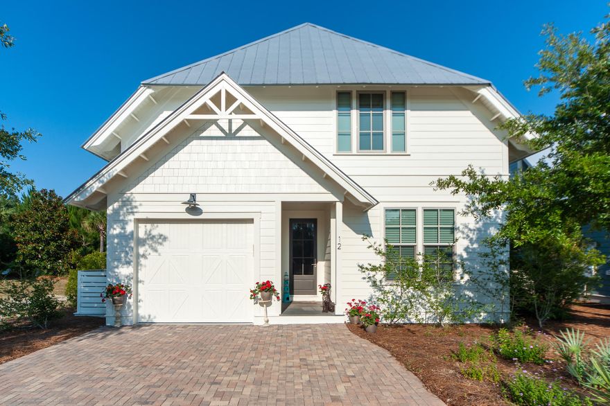 Cypress Dunes adjoins 3.2 miles of Tops'l State Park beach. Inviting beautiful interiors are bathed in natural light throughout this immaculate four bedroom four and one-half bath home with a garage. The Cypress Plan's foot print is large and only a few home sites can accommodate this plan. Located in the perfect setting, this residence is ideal for year round living or second home, in Cypress Dunes near beautiful uncrowded beaches, excellent schools, dining and shopping. The open floor plan with pristine site finished hardwood floors seamlessly integrates the living, dining and kitchen creating intimate spaces for gathering and entertaining. The living area lets on to a cozy screened porch overlooking nature and accommodates outdoor dining, plenty of seating and a flat screen tv. The gourmet kitchen boasts ample quartz countertop space and storage, top of the line stainless appliances, gas cooking and seating at the breakfast bar.  It is sure to please the resident chef.  The Master Bedroom Suite with hardwood flooring enjoys the convenience of the first floor while also providing privacy as three ensuite graciously sized bedrooms are on the second floor.    There is a sense of entry to the second floor with a landing that provides guests with a welcoming feeling.  Two of the three second level bedrooms are Junior Masters and one bedroom is also ideal for an office or study.  A few special features of this home include: insulated fiberglass exterior doors, impact resistant and maintenance free vinyl windows, Rinnai tankless gas water heater, dual control thermostat, 10 ft ceilings, 8 ft interior doors, R-19  insulation in walls, R-21 roof insulation and R-14 insulation in ground floors.    
Cypress Dunes has two resort-style swimming pools, a large jetted spa, two tennis courts, 650 sq. ft. fitness center, owners' clubhouse, outdoor fireplace, and recreational lawn area and so much more.  We invite you to tour 12 Cypress Circle and discover the beauty of living in Cypress Dunes.      