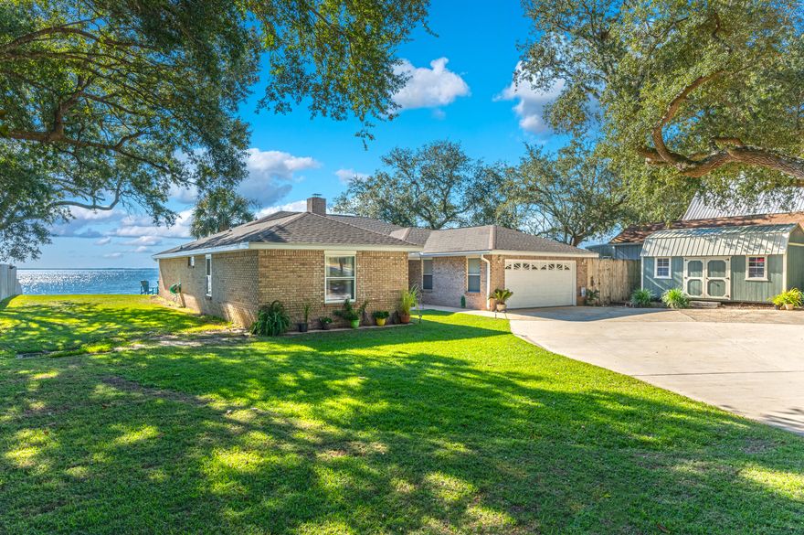 Once Upon A Time, and Happily Ever After! This could be You. Are you ready for easy living at its best? Look no further and get ready to relax in style. This home was not spared any expense in making it ready for the next Owners. With views and sunsets that can leave you breathless, this home comes equipped with a  4,000 lb twin motor 240v dual control boat lift, 55 tons of rock brought in to reinforce the seawall, fish cleaning station directly off the dock, a driveway that can park 17 vehicles, and No that is not a typo, and the list goes on. Upon entry, you have a formal living to your left and formal dining room to your right. As you enter the Den, you are greeted with vaulted ceilings, a double-sided fireplace, and views galore of the expansive yard and Choctawhatchee Bay! There is an enclosed Florida Room that is perfect for those rainy days to enjoy the view. Under the roof, you have 3 amazing size bedrooms, with the Primary Suite nestled on the Bay side to capture those beautiful sunsets. This bedroom has its own en-suite bathroom with double vanities, dual walk-in closets, and a stand-alone shower. Walk down the hall-way and you will find the other two bedrooms plus the 2nd full bathroom, complete with a whirlpool tub/shower combo. Did we mention fishing? This is also an Angler's paradise, or Angler in training with the amount of fish that can be caught from your private dock alone. This home is ready for new Occupants and will not last long, so make your appointment and take a look at this one before someone else makes the catch of a lifetime!
