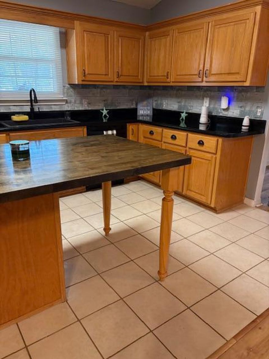 Enjoy the facilities at Holley By The Sea Recreation Area, then proceed to Eagle Lane, your residence which includes a spacious 12' by 39' Florida room. Vinyl flooring with a wood-look finish, and removable windows and screens added in 2024.  New Roof 2020. The home features updated windows from 2021 and vinyl wood-look flooring installed in 2023.   The kitchen is equipped with a stainless-steel side-by-side refrigerator, a nearly new black stove, a black dishwasher, a black microwave, and various other recent enhancements.   All-new plumbing was installed in 2025. Additionally, a new heat pump was added in 2021, thus ensuring comfortable temperatures throughout the seasons.  Leaves are no problem as 2021 leaf filter sits near roof. This property features... an inviting tiled front porch ideal for enjoying views of the neighborhood. The fenced backyard includes a sprinkler system, two landscaped flower beds, and a covered open patio adjoining the Florida room--providing excellent space for outdoor dining and relaxation.  Did I mention cathedral ceiling in living /dining are or the two French doors or two walk gin closets in Master bath, or built in kitchen island, a nice storm door in entrance is also included.  A very walkable neighborhood. 