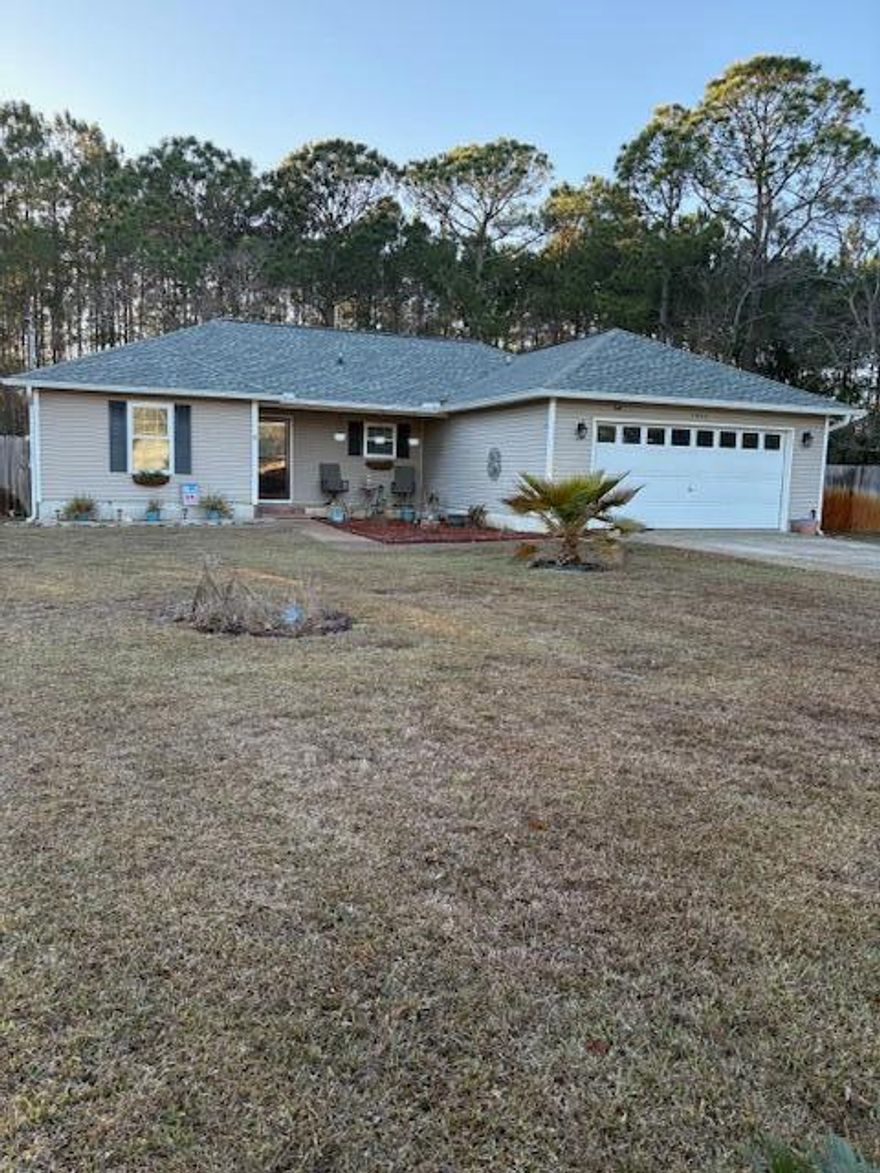 Enjoy the facilities at Holley By The Sea Recreation Area, then proceed to Eagle Lane, your residence which includes a spacious 12' by 22.5' Florida room. a covered porch/patio11.5'X 15 Vinyl flooring with a wood-look finish, and removable windows and screens added in 2024.  New Roof 2020. The home features updated windows from 2021 and vinyl wood-look flooring installed in 2023.   The kitchen is equipped with a stainless-steel side-by-side refrigerator, a nearly new black stove, a black dishwasher, a black microwave, and various other recent enhancements.   All-new plumbing was installed in 2025. Additionally, a new heat pump was added in 2021, thus ensuring comfortable temperatures throughout the seasons.  Leaves are no problem as 2021 leaf filter sits near roof. This property features.. an inviting tiled front porch ideal for enjoying views of the neighborhood. The fenced backyard includes a sprinkler system, two landscaped flower beds, and a covered open patio adjoining the Florida room--providing excellent space for outdoor dining and relaxation.  Did I mention cathedral ceiling in living /dining are or the two French doors or two walk gin closets in Master bath, or built in kitchen island, a nice storm door in entrance is also included.  A very walkable neighborhood. 