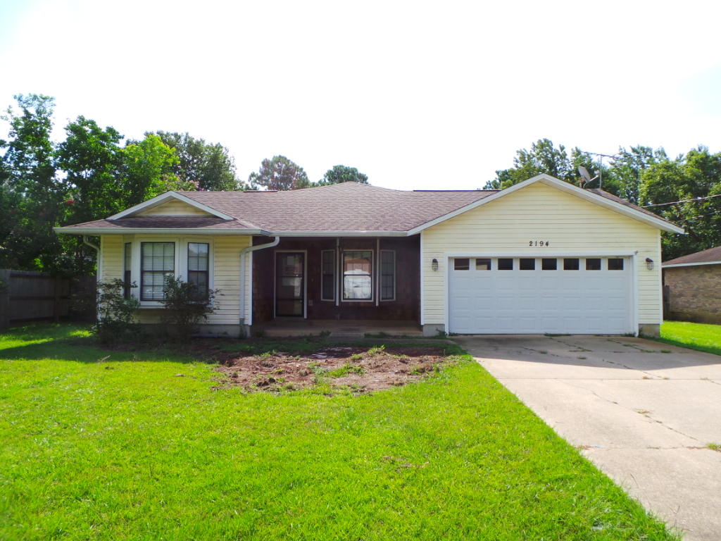 REO; 4 bedroom, 3 bath home in Navarre. Over 1900 sqft with double car attached garage. Covered front porch. Yard shed in back yard. Tiled floors throughout. Custom built cherrywood cabinets in kitchen with black appliances. Large master bedroom with corner placed his and her vanity and garden tub. Ceiling fans throughout. This beautiful home is ready for immediate move in!