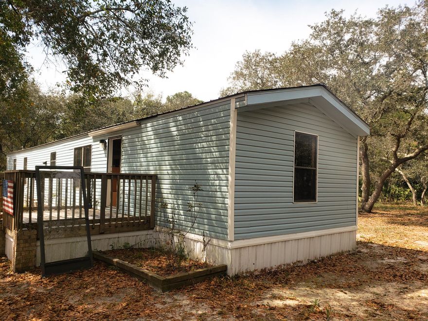 Located within steps to the Choctawhatchee Bay and convenient to Eglin Air Force Base and Mid-Bay Bridge this home would make a great starter home or investment property.  Situated on a beautiful half acre of unrestricted partially fenced property this renovated 2 bedroom, 2 bathroom mobile home is move in ready.  This home offers privacy on a quiet street just of Hwy 20 between Niceville and Freeport. Enjoy the bay breeze from the front porch.  There is also a screened rear porch, a detached storage building and fish cleaning station is an added bonus.  This home features a large walk in closet in the Master, split bedrooms, laundry room with new flooring, new A/C and recently painted. This property is being sold partially furnished and move in ready!