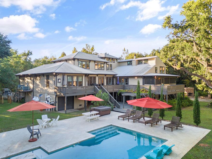 Welcome to Blackwater Bay Hideaway, a stunning, 5 bedroom, 4.5 bath residence featuring a private gated entrance to your waterfront escape in Robinson Point , complete with a beautiful oak tree lined driveway to the house. Providing the perfect setting for relaxation, unforgettable celebrations, or lucrative investment opportunities as a short term rental or wedding venue. This 3.13 acre retreat offers over 200 waterfront feet on Blackwater Bay with the most incredible water views. Featuring a private dock with covered boat and jet ski lifts, custom gunite pool with travertine deck and open pavilion pool house, 2 outdoor fireplaces, terrace, and plenty of room to make additions. Entering the foyer, you're greeted by the light filled space and the fusion of historical charm and modern enhancements. A staircase to the left of the front door leads you to 2 of the 5 bedrooms and a Jack & Jill bathroom. On the East side of the home is the open concept living area, dining room, and the chef's kitchen featuring a wine fridge, double walled ovens, gas stove with pot filler, and kitchen island complete with wash sink and pull out cooler and freezer drawers. All with amazing views of the backyard and waterfront, and gorgeous hardwood floors and ceilings with crown molding. The primary suite is just off of the living area. Wake up to the most amazing sunrise views from the comfort of your own bed. The luxurious ensuite is a dream, with soapstone countertop double vanity, walk-in closet with organization system, Roman shower, and a jacuzzi tub. The utility room is off of the kitchen and the primary, and contains the walk-in pantry. From the foyer and through the french doors, you are also welcomed into the original cottage home that has been remodeled as a den and guest suite with two bedrooms and two bathrooms. The den has a vaulted, wood beamed ceiling, fireplace, and access to the porches. Down the stairs, or take the elevator, to the first floor is the garage that extends the length of the house and can fit 5 cars, and houses an outfitted exercise room and workshop! Schedule a showing to see this one of a kind beauty today!