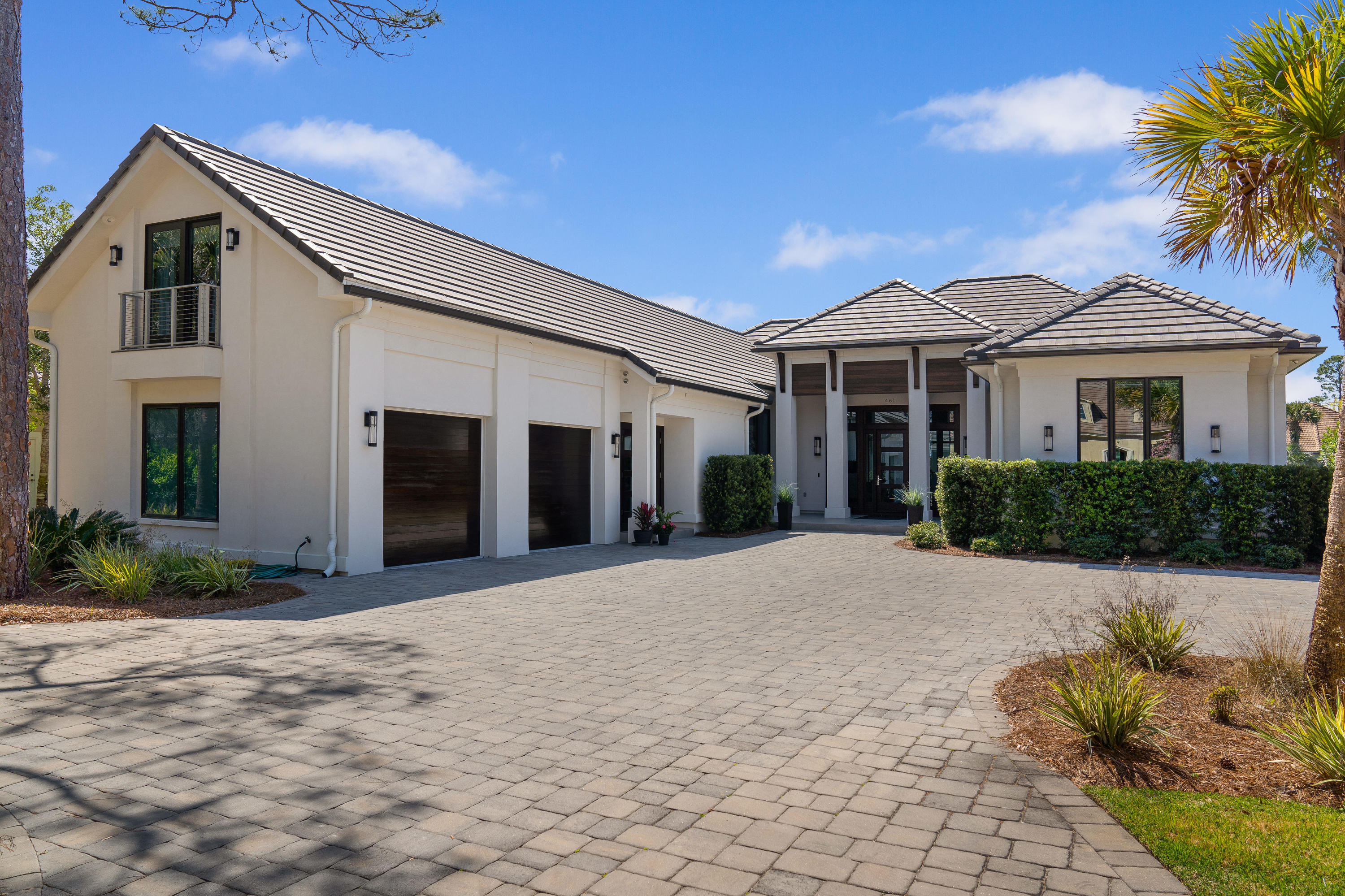 Indeed a show-stopper! This jewel of a home is located lakefront and just across the street from the Choctawhatchee Bay in the upscale Regatta Bay Golf & Yacht Club community! Custom designed and unique home to the area offers contemporary flair and stunning style, light and airy. Twelve foot ceilings and ten foot windows accent the voluminous space. Both interior and exterior are artfully finished. Imposing mahogany doors greet upon arrival not only at the main entrance, but garage doors also will impress. Entry introduces the open floor plan that expands the great room, dining area, and kitchen out to the screened Lanai, cocktail pool/hot tub, and lake beyond. Full view windows, with TV remote controlled blinds in main living areas, bring light and showcase the serene views. Family room is enhanced by a floor to ceiling stacked stone wall that encases a large screen TV and a dramatic electric logs fireplace. Its coffered ceiling adds architectural interest. Large porcelain flooring tiles grace throughout the home. Slider glass doors in main living areas and Master Bedroom open to the Lanai while enhancing the views. 

Kitchen's appeal is attractive and modern with KitchenAid stainless steel appliances to include refrigerator, convection and microwave ovens - all so easy to maintain. The built-in plumbed Miele Coffee System offers a delicious brew. Center island has a six gas-burner cooktop, adorned with under lighting for a dramatic effect. Island counter top is not only beautiful, but introduces the indestructible Dekton product, that is designed to be an improvement over the performance of quartz counter tops. Lots of counter space with modern-designed sleek cabinetry by Marquis Kitchen & Baths - features invisible roll out drawers. Kitchen pantry and cabinet storage is spacious. 

The Master Bedroom Suite, with split bedroom design, offers privacy, via barn door, to the comfort of the energy efficient Mitsubishi split heating and cooling system. Suite is designed to perfection as it overlooks the pool and lake, has direct access to the custom designed his/her closets, abundance of shelving, walled security safe, and room flows to a Master Bath that is amazing.  Spacious bath has separate vanities with exquisite granite counter tops, an over-sized walk-in shower, plus showcases a centered soaking tub - all complete the relaxing master suite. 

A hallway gallery located off the kitchen, announces the second bedroom - situated perfectly for guests' privacy with en suite bath, perfectly adorned with quartz vanity top.  Gallery hallway opens to a large laundry room with refrigerator in the hospitality area. Cabinets offer laundry folding area with the Dekton counter top.  Again, great storage and gallery leads to an open, modern stairwell with skylight. Upstairs, guest will enjoy private bedroom via slider barn door, with en suite bath, hospitality area with refrigerator, and the ambiance this design provides. Off back hallway gallery is a storage area/mud room with cabinet storage, and shower convenient to washing the dog or used as the pool shower.
 
The garage, touts mahogany doors, is heated and cooled, trimmed out to be enjoyed for over-flow party space, game room or man's cave in a comfortable conditioned environment. Other features include reverse osmosis clean water filter system, tankless hot water heater, Mitsubishi split system in garage also heats and cools upstairs area. All windows and slider doors are by Anderson. The house is a "smart house" with surround sound and has Wi-fi enabled Mr. Q  garage app, Ring doorbell, smart TVs  and audio visual equipment will convey with sale.  Windows are tinted for economical heating and cooling. Home does have a security alarm. Property is located in Cobra Zone, Flood Zone X.

Regatta Bay Golf and Yacht Club offers a serene upscale 
neighborhood along the Emerald Coast that is enjoyed by all ages. All owners and guests have privileges to tennis courts, pickle ball courts, a large Olympic size pool, kiddie park and pool, plus walking trails and nature preserves abound. The golf course is rated among the tops in the state and membership is not mandatory to be a resident. The Gulf of Mexico is only a golf cart ride south a few blocks. Buyer is to verify all important data.

