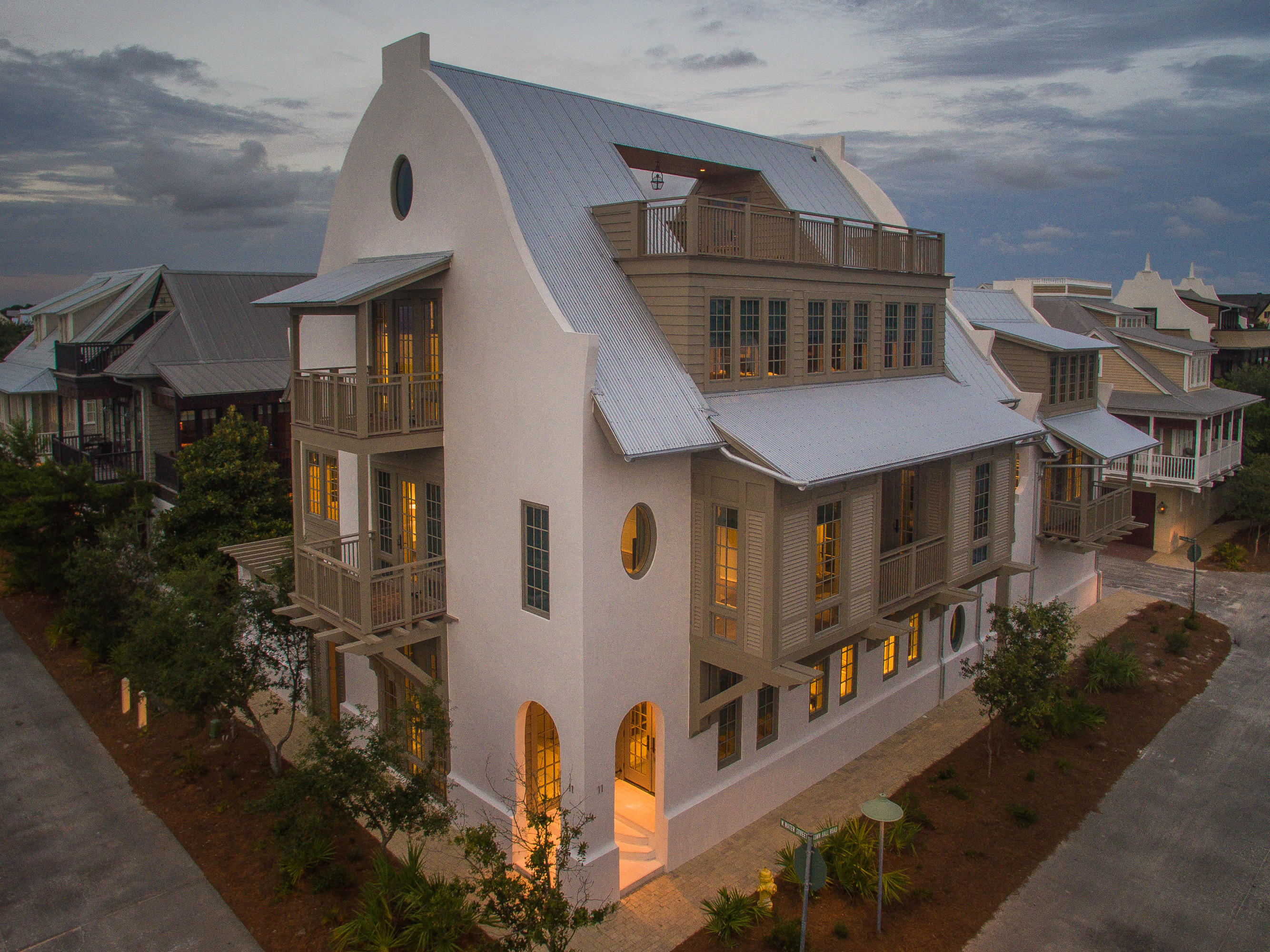 Quite possibly the most enviable home in all of Rosemary! This 5000+ sf main house and 700+ sf carriage house will astound your senses. Upon entering the main residence, you immediately soak in the soothing design and architectural detail, and take note of the elegant lighting. Smooth Venetian plaster walls meet soft, white, Peacock Paver floors. Your eyes instinctively follow the floor that extends to a beautiful courtyard with wood burning fireplace and an inviting exercise-jetted pool. Before you are drawn to step out of doors, your attention is captured by gorgeous slabs of Castello marble that grace the one-of-a-kind custom designed Karpaty cabinetry in the incredible kitchen. The space is cleverly divided into before and after ''stations'' for meal preparation and cleaning.