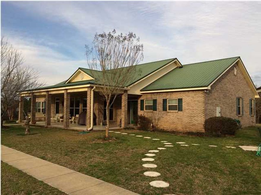 Country Living at it's best. Beautiful Brick/Vinyl Home with Double Car Garage sitting on 53.35 acres in Escambia Farms! Professionally Landscaped yard. Ceramic Tile in all wet areas of the home. Granite Countertops and Hardwood Floor in living areas. Vaulted Ceilings in Living Room. Fireplace for those cold winter nights. Sit outside in your Florida room to look out the glass doors and large windows and watch the deer graze in your own private pasture. Master Bathroom has stone walls in Shower. Garage has built in Staircase going to the attic. New long lasting metal roof was put on in 2004. New water heater installed in January 2015 and new pump installed in February 2015. Private Well for drinking water.