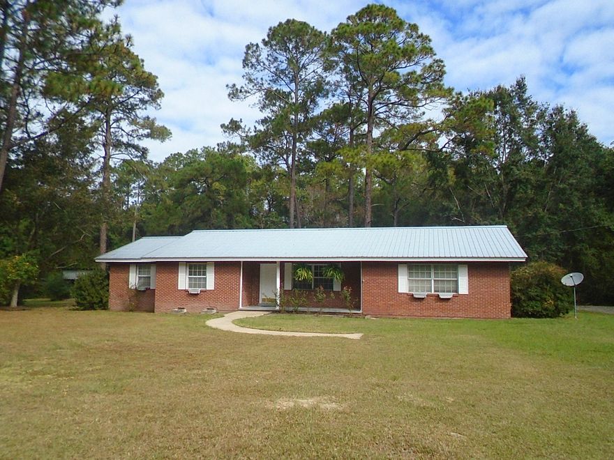 HUGE PRICE REDUCTION -- Spacious home on 2.5 acres located on Bob Sikes Road just a short distance from Hwy 331. City has zoned the property commercial(C-2) so it is perfect for an at home business. Kitchen includes an island with breakfast bar, ceramic tile flooring, recessed lightening, great built ins, all appliances and more. Stone fireplace in family room. Spacious master bedroom and master bath with double vanity, separate shower, jetted tub and walk in closet. 3 additional bedrooms - one includes built in chest and desk. Large deck on the back of the home to enjoy. Attached carport with storage area. The 2.5 acres includes a large 35 x 14 barn/workshop plus shed. Small fenced in area for pets. Plenty of space for gardening or whatever your need may be. Home in good condition. As-is.