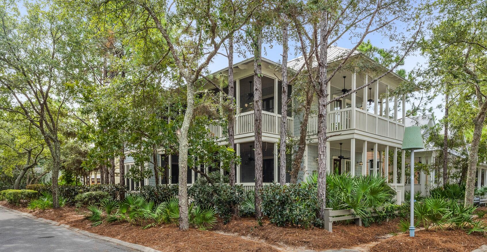 Located in the heart of the Camp Watercolor district, this amazing home offers not only a fantastic location, but a truly unique setting with lush landscaping and mature trees.  With a corner lot and four porches, you can sit back in a variety of porch swings or rocking chairs and enjoy coastal breezes and the resort lifestyle that is truly Watercolor.  A wide open kitchen joins a open concept dining and living room with an abundance of windows and doors opening to a screened porch to have even more space to live and play.  With on suite baths in every bedroom and a separate carriage house, this home can be a fantastic full time, rental or second home for a true getaway.  Wide plank wood floors, shiplap walls and custom tile bath and showers round out this beautiful home.
