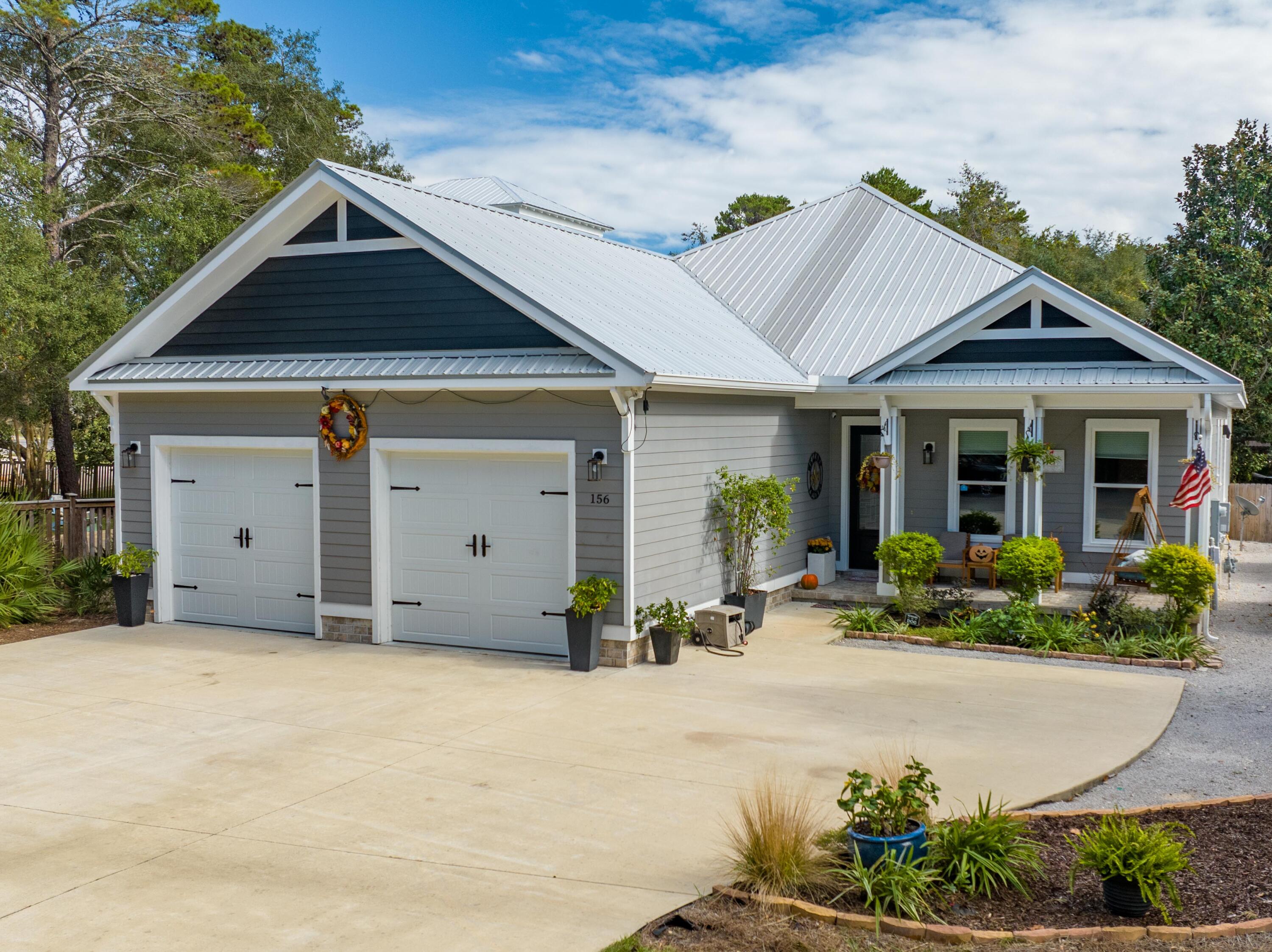 2018 custom built, one level home with 2-car garage & open parking for over 10 cars! Located just 4 blocks from a secluded beach access near Topsail Park. It boasts a chef's kitchen with a top of the line gas stove, a spacious island, and a roomy walk-in pantry. With 10-foot ceilings, porcelain plank tile flooring, solid room doors, barn doors, crown molding, and custom black out shades this home exudes elegance. The open living space adorned with a wooden beam encompasses the living area with a gas stone inlay fireplace, wet bar, large dining area, and gourmet kitchen. Egress outdoors to the screened porch to enjoy the 13' swim spa and a summer kitchen with grill and burner any chef would dream of. Buyers will love the stairs leading to the fully foam insulated attic. providing additional storage or work space. Beach lovers will appreciate the home's proximity to a secluded beach access near Topsail Park, and residents can enjoy biking through the park or on 30A. Situated on the west side of 30A in a quaint, tree-lined neighborhood, this property has no HOA fees and is in a low-risk X flood zone. Additionally, there's a whole-house filter in place. Negotiable separately is an infrared sauna, garage freezer & fridge, washer/dryer, furnishings and free standing appliances.