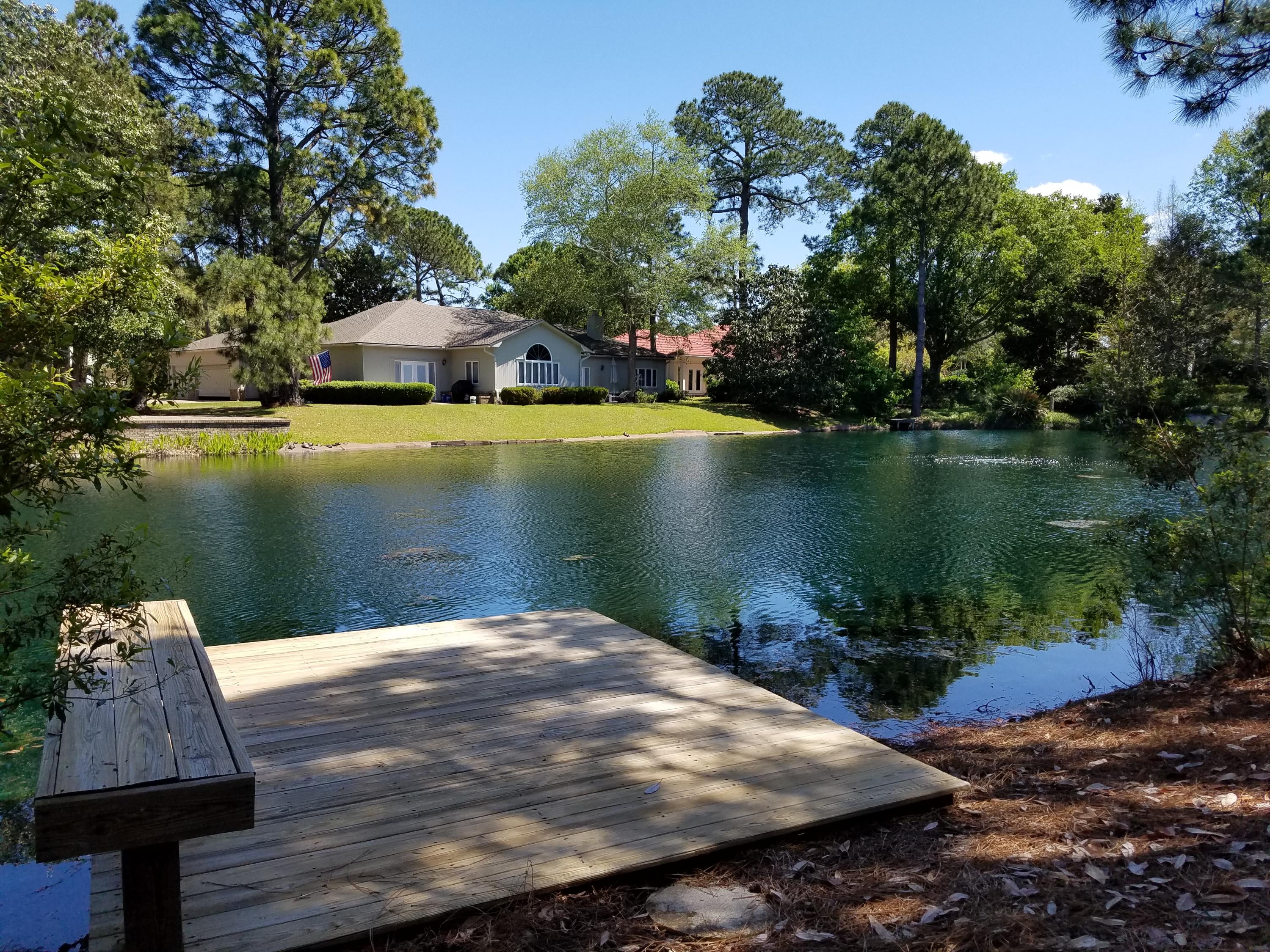 Lakefront home with dock located in Prestwick! There is plenty of space to build a garage or carport with ARB approval. Large, open floor plan between the living area, dining and kitchen. This home has rich hardwood flooring throughout the entire living area and kitchen, new coastal living room furniture, granite counters, crown molding, screened porch, open patio, and a large back yard with a private dock on the lake. There's two bedrooms and two full baths on the main floor with the master suite and private balcony overlooking the lake on the 2nd floor. 2017 assessment fees are $257/month to Prestwick Owners Association and $362.75/quarter to Sandestin Owners Association.