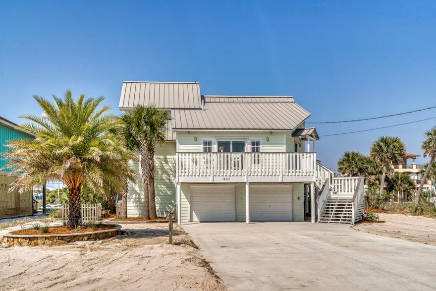 Gorgeous WATERFRONT, Deep Water Canal Home with 80+ Feet of Frontage, Seawall, a Gunite Saltwater Pool, 10K lb Boat Lift & Davit Crane, no HOA, and Panoramic Views of the Santa Rosa Sound! This 3 Bedroom/2 Bath Home is Perfect for the Boating and Water Activity Enthusiast. As soon as you enter, you'll feel the openness the Main Level provides, with Tall Cathedral Ceilings, Open Living & Dining and Tons of Natural Light. This wonderful home was Meticulously Maintained and boasts Updates galore, such as Newer Dock and Dishwasher in 2017, New HVAC Smart System with Sensors and Dryer in 2019, and New Driveway, Pool Pumps, and Landscaping all in 2020. The Kitchen / Dining Area has new low E High Efficiency Sliding Doors, Walk-in Laundry Closet, Spacious Pantry with Built in Cabinetry... ..& Shelvingand Stainless Appliances. 

The Back Yard is an Oasis sitting on one of the Widest Beach Canals, with Lush Tropical Landscaping, Newer Composite Dock, Gunite Saltwater Pool equipped with Lighting & Waterfall, Outdoor Shower, Covered Massive Patio on the Ground Level, and Expansive Composite Railing and Decking on the Main Level overlooking the Canal and Santa Rosa Sound. Right from there you have your 10K pound Boat Lift, Davit Crane, Jet Ski Holding Fixtures, and a pass-through Garage for ease of Jet Ski towing. It's an Amazing Place you have to see and experience for yourself, where you'll see unforgettable sunrises and sunsets. 

The front of the home has a Sizable Deck with Santa Rosa Sound Views, an oversized Driveway with plenty of Parking for RV with RV Hookup, Toys, and Vehicles, and the steps leading up to the main level are very wide with built-in lighting. The Garage has Space for two Cars plus Space for Family Sized Golf Cart and comes with an Enclosed Bonus Room, currently used for workout / game room, and Built-in Shelving & Work Bench. The entire yard is bordered with 12 Mature Palm Trees, comes sodded in the rear and is perfectly Beach-Landscaped with Irrigation System for ease of Maintenance. 1463 Arkansas comes with a 50 Year Standing Seam Metal Roof and Hardi-Plank Siding for easy and a durable beach home.

Additionally, there are Tiled Floors and Recessed Lighting throughout with plenty of Extra Storage areas in the Living Area and under the Stairwell. Every Room of this Magnificent Home has Views of the Santa Rosa Sound and Canal. Positioned near the Cul-de-sac it's location provides a more private feel and Quite Street. This home was not used as a Vacation Rental and has Been Very well Maintained and Loved.  It would also Make a Perfect Secondary Home/Vacation Getaway. 

Navarre Beach is one of the last places with the old Florida feel and has been coined "Florida's Most Relaxing Place."  There's so much to do right from your Home and Backyard or go explore and enjoy additional Leisure on Florida's Longest Fishing Pier, visit the nearby Parks, hiking/biking trails, or relax on the Gulf of Mexico's White Sandy Beaches with Emerald Hued Waters. Navarre is also home to one of the most Gorgeous Stretches of unaltered beaches in the world at the Gulf Islands National Seashore. Don't miss this Fantastic Opportunity to Own a Piece of Paradise!