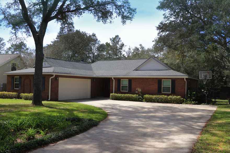 Well Maintained!!Brick on 3 sides and hardiboard on the back of the home. There are so many updates! New Roof 2015, All new hurricane rated windows 2009, garage door hurricane rated, All new interior doors installed 2015, new water system 2013, hvac system 2013. Open floor plan with kitchen nook and living area with a wood burning fireplace and blower.Kitchen has granite counter tops, living area and hallway hard wood floors. Both the guest bath and master bath have been renovated with new cabinets. The guest bath has a newer tub and granite wall accents. The master bath has updated cabinetry and an oversized tiled shower with two shower heads. The yard is beautifully landscaped and the back yard has blooming flowers off the back deck. And an exterior shed for extra storage.