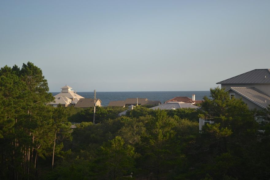 Reduced! Build to enjoy this lot's high elevation, cool breezes, and beautiful Gulf views in the quiet, wooded neighborhood of Beach Highlands. No HOA fees or restrictions. No build out limitations. Two beach accesses just .3 miles away: S. Bishop or Stallworth with shower and bike rack. Short walk to Stinky's locally owned seafood restaurant. Convenient to Topsail Hill Preserve State Park with over 3 miles of pristine beach and majestic dunes. Shopping abounds: Publix, Silver Sands Designer Outlet,Grand Boulevard,local art and antiques. Easy access to miles of biking and walking paths along 30A. Buyer to verify all data and dimensions.