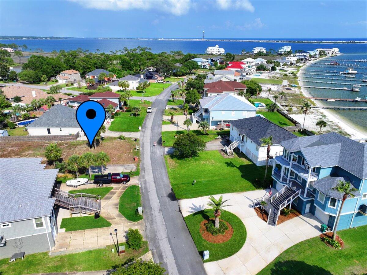 The ''Four Palms Villa Property'' if you will! This beautiful lot boasts 4 mature palm trees, and 2 smaller adolescents. All that is missing is YOUR custom build. The lot is a SURVEYED vacant lot with DEEDED BEACH ACCESS, on a cul-de-sac. There is a GEOTECHNICAL EXPLORATION REPORT including a SITE LOCATION MAP, TEST LOCATION PLAN, GRAPHICAL LOGS OF THE SOUNDINGS, a UNIFIED SOIL CLASSIFICATION CHART and important notes about the Geotechnical Report. These will convey from current owners. Emerald Pointe has a private community beach on Santa Rosa Sound with picnic area, bbq, and area for kayak or SUP launch available for its residences to use. Lot has been recently cleared and has utilities already available.