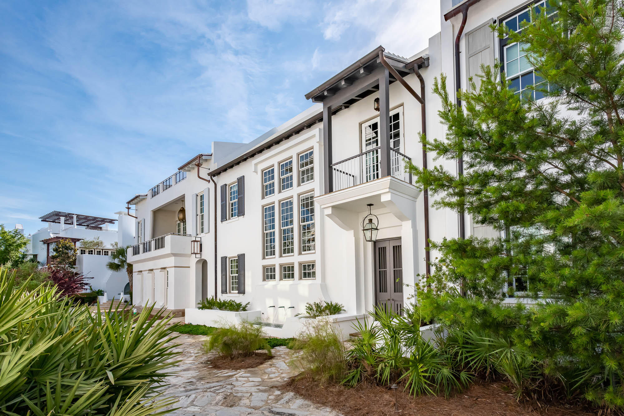 TMc Architecture created the quintessential Antiguan influenced home that Alys Beach personifies, pairing the indoor living with the outdoor.  Connectivity begins with the 1st level kitchen, dining, & living rooms that open to the private courtyard hosting an enclosed loggia featuring beverage center, grill, & fireplace.  Operable glass doors function to enclose for those chilly evenings.The primary elevation fronts the award-winning Sea Garden Walk pedestrian path creating a special environment for guests to enter the home and easy pedestrian travel to the private owners Beach Club, Caliza Pool, and Zuma Wellness Center.  North to Lake Marilyn & the nature preserve or south to the beach by way of Sea Garden Walk.  Entering the home draws attention to the ebonized machined steel,