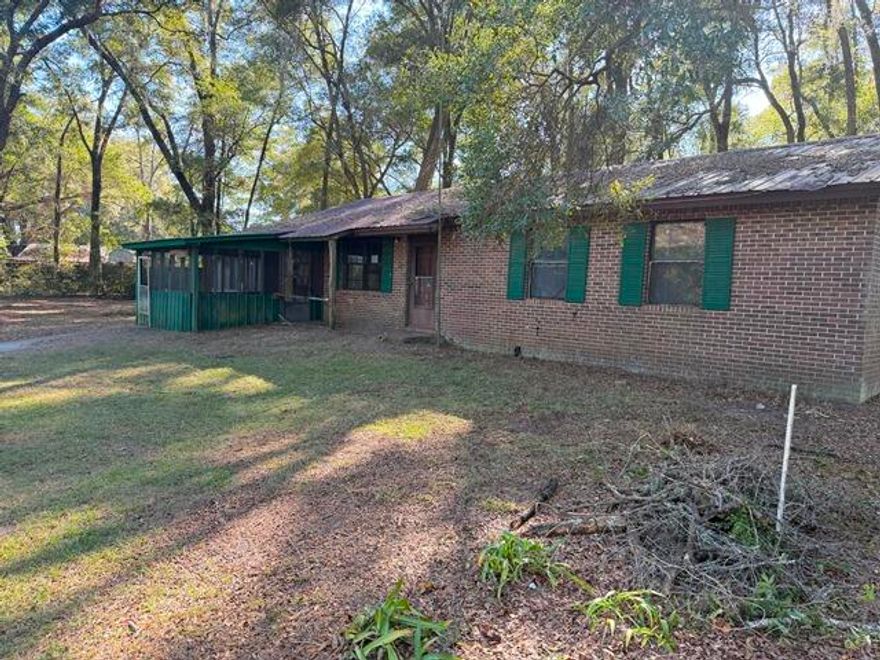 Escape to your own quiet wilderness retreat surrounded by mature oaks and natural beauty. This classic brick ranch sits on a spacious one-acre lot, offering plenty of room to spread out and enjoy the outdoors. Excellent fishing and hunting opportunities are just minutes away, making it the perfect haven for nature lovers. The home features inviting covered porches--ideal for relaxing and taking in the tranquil surroundings--as well as a large outbuilding for storage, hobbies, or a workshop. With ample parking space and the calm of the countryside, this property offers both comfort and serenity.