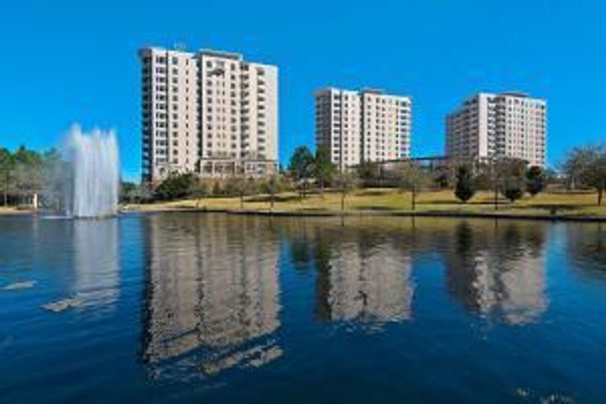 Luxury Living! Elegant, open Castleton floorplan featuring panoramic bay and golf course views from the wrap-around balcony.  Upgrades include: gourmet kitchen with new appliances, island and granite counter tops. It features gorgeous new 'real' wood floors, stone fireplace, replaced HVAC system and new water heater.  It also comes with a coveted golf cart parking space.One Water Place is wonderful community within Kelly Plantation's 900 gated acres with a championship Freddy Couples golf course. OWP has amenities galore with a state of the art fitness center, spa treatment rooms, indoor steam rooms, sauna and Jacuzzi, garden style pool and a heated lap pool, 3 guest suites, wine rooms, elegant club room, card room, catering kitchen, conservatory, hobby room, library, sports bar and more