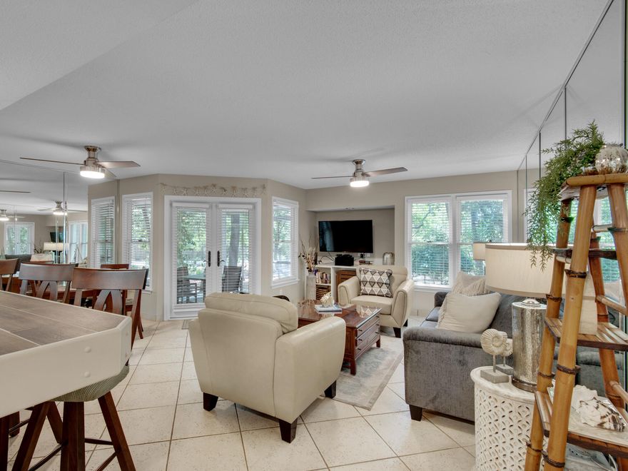 Price reduction and now lowest at HD. A  favorite with guests, first floor walk out from the front door and back porch.  With over 800 square feet, it's spacious enough for full time living and supports a family or group of friends with large private suite plus a pull out queen sofa bed in living with a 1/2 bath. Bright and cheery with a white kitchen, breakfast bar, tile flooring throughout, beachy furnishings. Private end unit with extra windows floods the home with natural light.  The attached oversized screen porch with french doors adds additional living space for year round entertaining. Unit is equipped with washer/dryer, microwave, range, dishwasher and refrigerator with ice maker. The owners lovingly made improvements with a remodeled private bath with large walk in tiled shower. Kitchen is updated with open shelving and large work space with island for additional seating. A dining area is great for meals, family games or a work station. Enjoy the lush landscape surrounding these homes giving you the privacy after a long day of fun activities. Seasonal tram takes you to the private deeded community beach. Several pools and hot tubs including a heated pool in the winter months. Outdoor grilling area. Kids playground. Tennis and pickleball at the club, pay per play. A quick bike ride along the sidewalk on 98 takes you to Sandestin amenities, Scenic Gulf Drive for restaurants, live music and walking paths. Securely guard gated 24/7. 