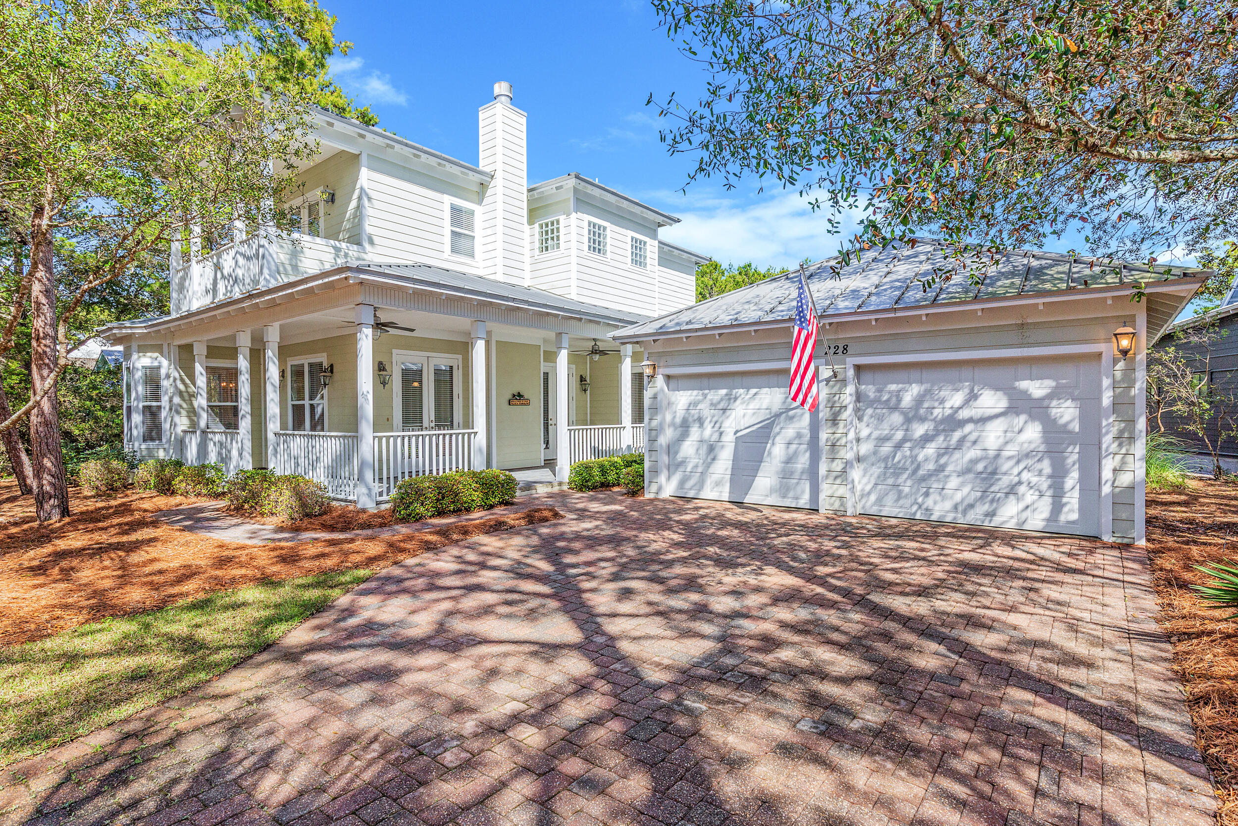 Great 30A East location with a short walk, golf cart or bike ride to your deeded beach access with golf cart & bike parking. This Florida Cottage home with oak hardwood engineered flooring throughout the main level has soaring 10 feet ceilings with crown molding on both levels. The front covered porch welcomes you to come inside to an open living and kitchen area with fireplace. The kitchen has granite counters and GE Profile stainless steel appliances. The primary bedroom is on the main level with french doors, spacious walk in closet and expansive bath with garden tub, shower and double vanities. There is a guest suite on main level as well as two additional bedrooms with sleeper sofas and ensuite baths on second level. Private pool with screen enclosure and 2 car garage.