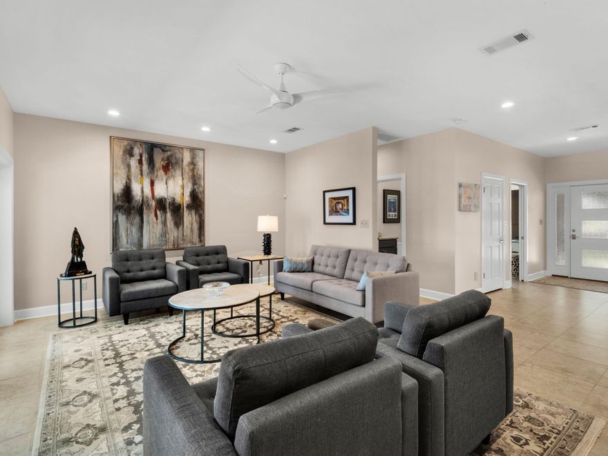 This contemporary custom-built home sits high and dry on an 80-foot high bluff overlooking a beautiful 119-foot private beach. From the elevated deck, it delivers expansive views of Escambia Bay, Garcon Point, Gulf Breeze and Garcon Point Bridge. This meticulously kept home occupies a two-acre lot with steps leading down to the golden sand and the private beach below. This single-story residence's brick and cedar construction echoes the mature magnolias, live oaks, pines and black walnut trees scattered throughout the fenced backyard. Lack of space will never pose a problem at this five-bedroom, three-and-a-half bath home, boasting a three-car garage and a full-height attic above. Floors throughout the home are covered with stunning 24-inch Italian tiles, while the kitchen, bathrooms and wet bars boast a total of 1,500 square feet of sleek granite countertops. Fully renovated, the home features a flowing open floor plan that is designed for large-scale entertaining or family living. Beyond the living room and dining room, the huge kitchen has island seating for eight. Custom cabinetry, high-end GE Profile appliances and a gas cooktop with a retractable hood make this a true chef's domain. The butler's pantry keeps everything neatly stored out of sight. Matching custom-built cabinets and strategically placed skylights continue into the great room. A large den allows everyone to find their own private space for reading or watching TV. Relax in front of the gas fireplace, pour drinks from the wet bar and savor the stunning views of the shimmering bay. For outdoor living, it's hard to beat the refurbished deck, accessed from the den through multiple sets of French doors. It comes with its own outdoor kitchen, refrigerator and rebuilt gas grill. Alternatively, take a dip in the 40,000-gallon screened pool, surrounded by a freshly painted deck. Retire for the night in the reconfigured master suite, which is a sanctuary of calm. A boutique-sized walk-in closet, private balcony, and a wet bar with refrigerator provide added amenities, while the master bathroom has a deep soaker tub and a separate walk-in shower. Two guest bedrooms and a new bathroom are located in a separate wing, for added privacy. A studio with a bathroom and a private entrance could be used for independent family members. The entire home has had a thorough makeover, including a new master HVAC, split A/C unit and a new gas water heater. The landscaping remains lush and green thanks to a new Rain Bird sprinkler system fed from a dedicated well. Additional updates include a new pool liner, pump, filter and pool heater, new fencing, a newly installed porch and a brand new hurricane-rated roof with skylights. For added peace of mind, the home had new custom hurricane-rated exterior windows and French doors in 2024, complemented by traditional hurricane shutters. Despite its remote coastal location, this magnificent home is just five miles from downtown and minutes from local shops, restaurants, schools, hospitals and the university. 