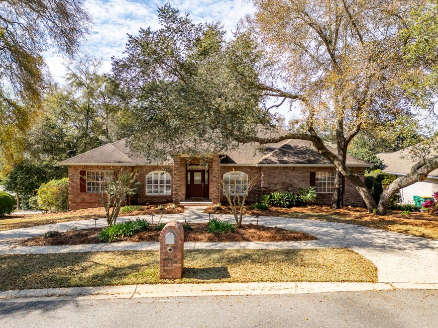 This is your LUCKY day!  This custom-built home is available!  Location, location, location!   This all-brick beauty is in the sought after Rocky Bayou neighborhood, featuring gorgeous homes, sidewalks, lakes, and a golf course country club with pool.  This home has so many options that your family will appreciate!  Let's start with a corner lot, 2 separate driveways, 3 car garage, large storage shed and lovely landscaping.  Step inside and you'll find architectural details like columns, crown moldings and tray ceilings.  Off the entry is a formal dining area on one side and an office space on the other.  The living room greets you with a gas log fireplace and large windows that bring a tranquil view of nature indoors.  Then step out onto the expansive deck for grilling or relaxing CLICK> The kitchen is open to the living room with a breakfast bar and breakfast nook overlooking the deck and trees.  You'll also appreciate the tile backsplash, center island with cooktop, Silestone counters, French door fridge and pantry.  The main bedroom is spacious enough for all your furniture or a sitting area.  Plus, there's access to the deck to enjoy a cup of morning coffee.  Two walk-in closets with custom built-ins await you and a lovely ensuite bathroom with double vanities, a glass shower and soaking tub to enjoy.  Conveniently located off the main bedroom is the laundry room with its own sink and extra cabinets for storage.
A total of 4 bedrooms and 4 bathrooms (3 full and a half bath) means there's space for family and friends to stay or visit!  You'll also love sharing the large family/media room!  This flexible space includes a large screen TV w/built-in surround sound speakers and recessed lighting.  No worries about losing power there's a home generator too!  Downstairs you can step out onto the back porch and listen to the birds.  Close to A rated schools, Eglin AFB, shopping, restaurants, the Mattie Kelly Arts Center $25 million dollar entertainment venue and so much more!  Call today for your chance to own your piece of Niceville! 