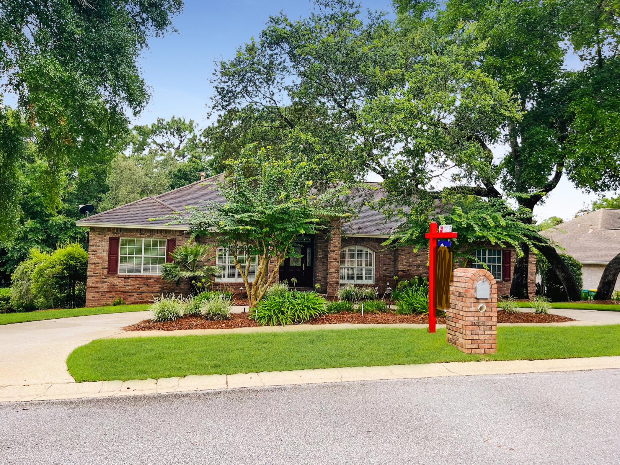 A HOME to MAKE MEMORIES in! This custom-built home is available! Location, location, location! This all brick beauty is in the sought after Rocky Bayou neighborhood, featuring gorgeous homes, sidewalks, lakes, and a golf course country club with pool. A home with many options that your family will appreciate! Let's start with a corner lot, 2 separate driveways, 3 car garage, large storage shed and lovely landscaping. Step inside and you'll find architectural details like columns, crown moldings and tray ceilings. Off the entry is a formal dining area on one side and an office space on the other. The living room greets you with a gas log fireplace and large windows that bring a tranquil view of nature indoors. Then step out onto the expansive deck for grilling or relaxing CLICK>> The kitchen is open to the living room with a breakfast bar and breakfast nook overlooking the deck and trees. You'll also appreciate the tile backsplash, center island with cooktop, Silestone counters, French door fridge and pantry. The main bedroom is spacious enough for all your furniture or a sitting area. Plus, there's access to the deck to enjoy a cup of morning coffee. Two walk-in closets with custom built-ins await you and a lovely ensuite bathroom with double vanities, a glass shower and soaking tub to enjoy. Conveniently located off the main bedroom is the laundry room with its own sink and extra cabinets for storage.
A total of 4 bedrooms and 4 bathrooms (3 full and a half bath) means there's space for family and friends to stay or visit! You'll also love sharing the large family/media room! This flexible space includes a large screen TV w/built-in surround sound speakers and recessed lighting. No worries about losing power there's a home generator too! Downstairs you can step out onto the back porch and listen to the birds. Close to A rated schools, Eglin AFB, shopping, restaurants, the Mattie Kelly Arts Center $25 million dollar entertainment venue and so much more! Call today for your chance to own your piece of Niceville!
