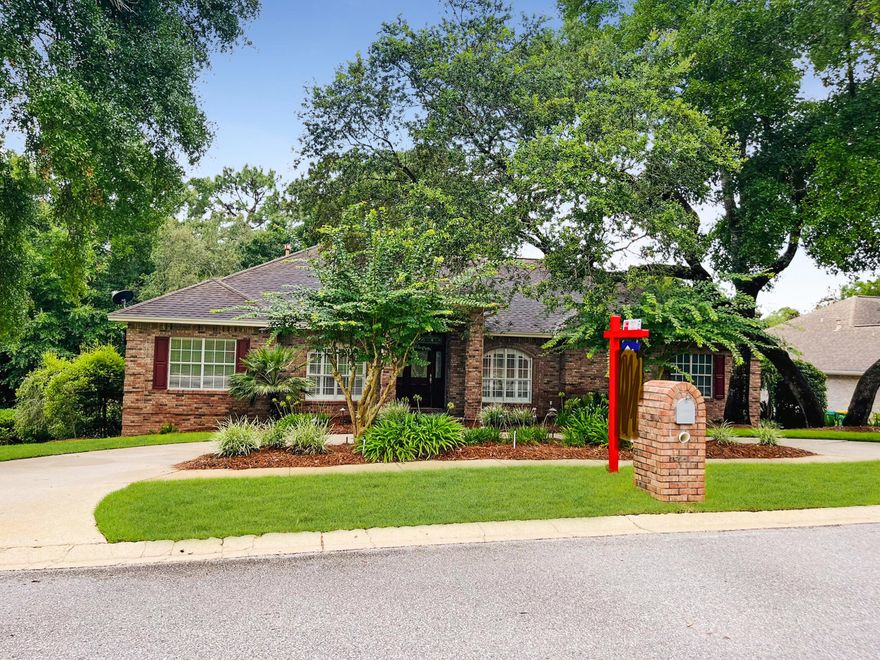 A HOME to MAKE MEMORIES in!  This custom-built home is available!  Location, location, location!   This all brick beauty is in the sought after Rocky Bayou neighborhood, featuring gorgeous homes, sidewalks, lakes, and a golf course country club with pool.  A home with many options that your family will appreciate!  Let's start with a corner lot, 2 separate driveways, 3 car garage, large storage shed and lovely landscaping.  Step inside and you'll find architectural details like columns, crown moldings and tray ceilings.  Off the entry is a formal dining area on one side and an office space on the other.  The living room greets you with a gas log fireplace and large windows that bring a tranquil view of nature indoors.  Then step out onto the expansive deck for grilling or relaxing CLICK>> The kitchen is open to the living room with a breakfast bar and breakfast nook overlooking the deck and trees.  You'll also appreciate the tile backsplash, center island with cooktop, Silestone counters, French door fridge and pantry.  The main bedroom is spacious enough for all your furniture or a sitting area.  Plus, there's access to the deck to enjoy a cup of morning coffee.  Two walk-in closets with custom built-ins await you and a lovely ensuite bathroom with double vanities, a glass shower and soaking tub to enjoy.  Conveniently located off the main bedroom is the laundry room with its own sink and extra cabinets for storage.
A total of 4 bedrooms and 4 bathrooms (3 full and a half bath) means there's space for family and friends to stay or visit!  You'll also love sharing the large family/media room!  This flexible space includes a large screen TV w/built-in surround sound speakers and recessed lighting.  No worries about losing power there's a home generator too!  Downstairs you can step out onto the back porch and listen to the birds.  Close to A rated schools, Eglin AFB, shopping, restaurants, the Mattie Kelly Arts Center $25 million dollar entertainment venue and so much more!  Call today for your chance to own your piece of Niceville! 