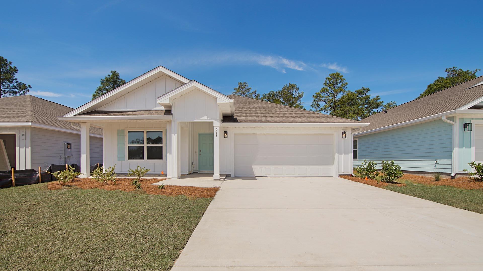 Welcome to 245 Eunola Lane, a new home at Ashton Park Phase III in Freeport, Florida. This home is move in ready and features a covered front porch perfect for an outdoor seating area and a light-filled foyer that effortlessly flows into the heart of this inviting 4-bedroom, 2-bathroom home. Off the entry hall, you will find two generously sized bedrooms, each with its own large closet, separated by a shared full bathroom. The third guest bedroom is located off a hall with laundry room offering a private retreat for guests or a functional home office or den. The heart of the home is the open-concept living space, where the kitchen, dining area, and living room merge seamlessly under 8-foot ceilings with EVP flooring in all common areas. The kitchen has a large center island with room for bar seating and spacious pantry. Kitchen features include granite countertops, a stainless-steel appliance package with stove, microwave and dishwasher as well as beautiful white cabinetry.
The primary bedroom located at the back of the home for privacy and has plush carpet. It features a spacious bathroom with an oversized walk-in closet, a dual sink vanity, open shower, and a large soaking tub as well as a separate water closet. Stepping outside through the glass door, the covered patio invites you to relax and enjoy the scenic surroundings. With its thoughtful design and high-quality finishes, the Cali floorplan delivers comfort and style for modern living.